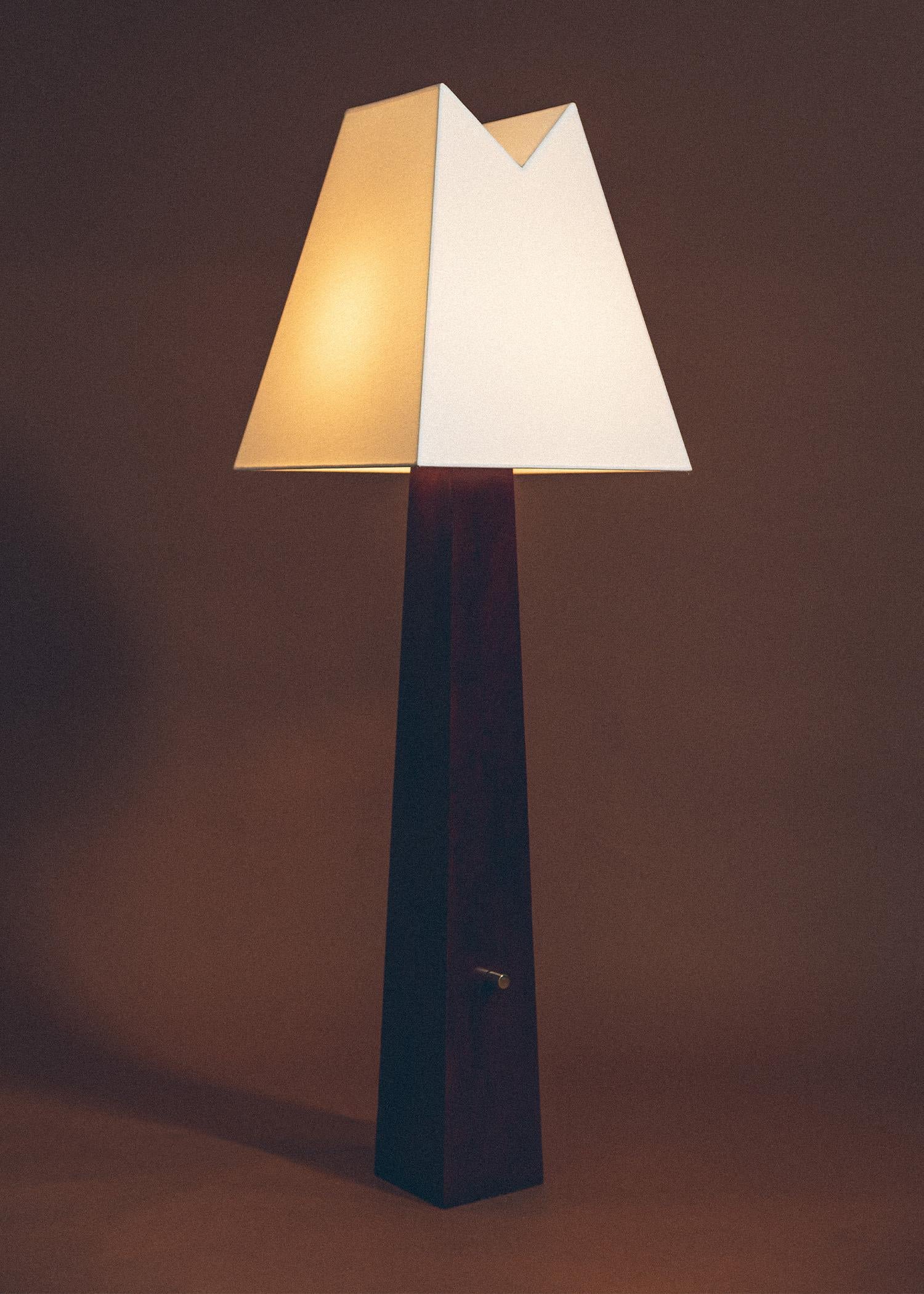 Born of nostalgia, the Alpine Lamp echoes natural forms and mountainous contours. The natural wooden base grounds the piece in earthy materials, evoking the altitude of Utah forests; the “V” of the lampshade mirrors the notch in Lone Peak, a