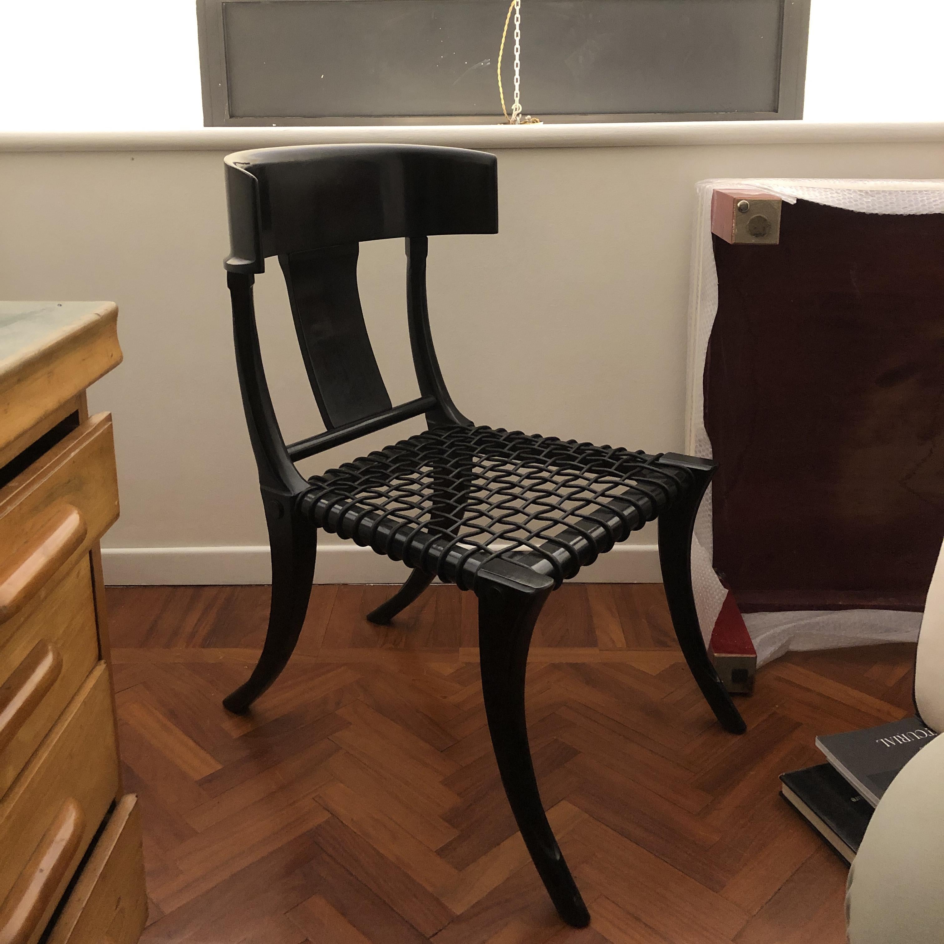 Klismos customizable dining chairs with saber legs, black lacquered wood and black woven leather seats. Available in other colors and upholstery.

Klismos are walnut wood chairs with deep and large seat and back wraparound feeling backrest. These