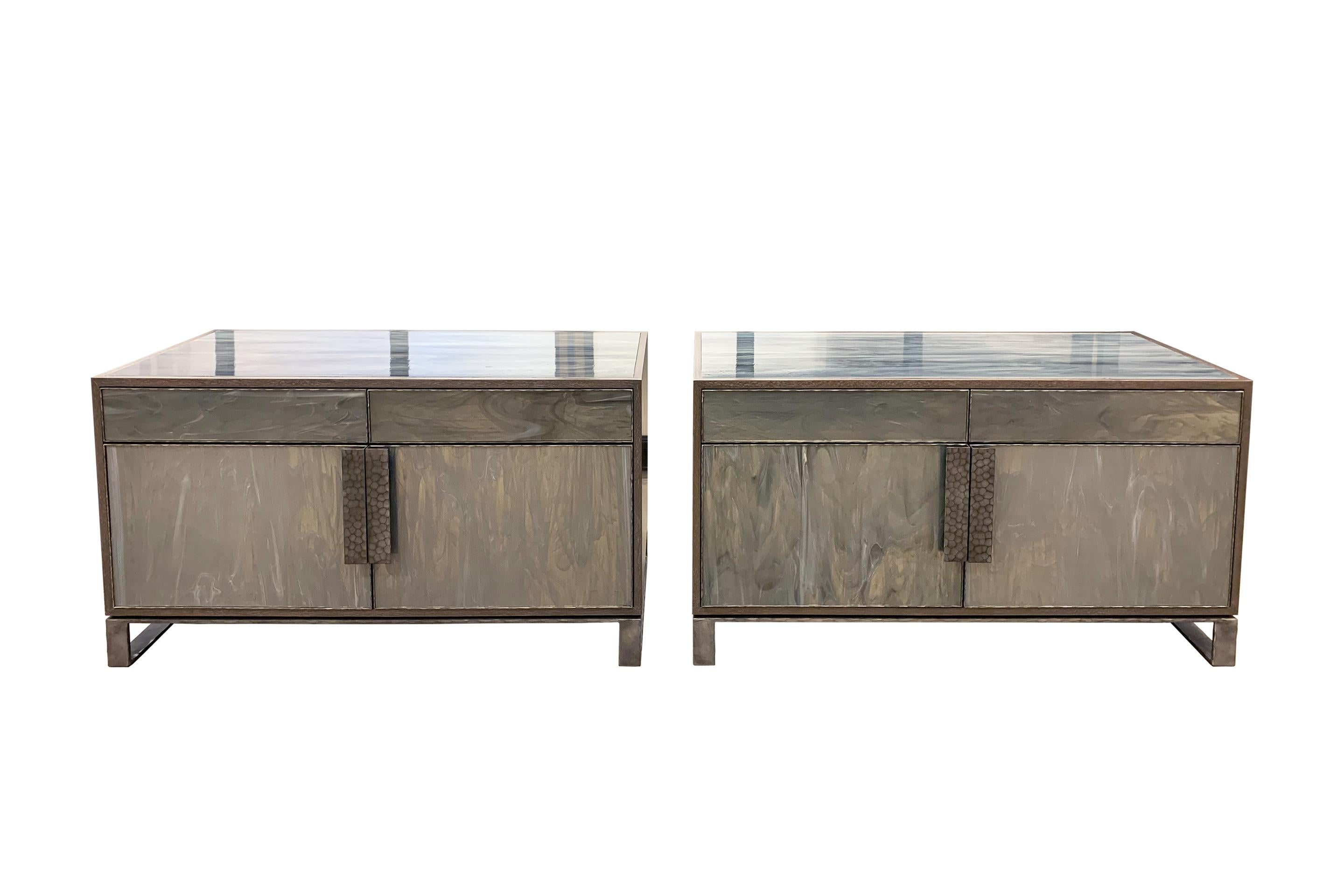 This chelsea buffet or sideboard by Ercole home has a 2-drawer and 2-door front, with Earl gray ceruse wood finish on oak.
Handcut glass panels in wispy gray silver are on the drawers, doors and top surface.
Hand-hammered metal framed doors,