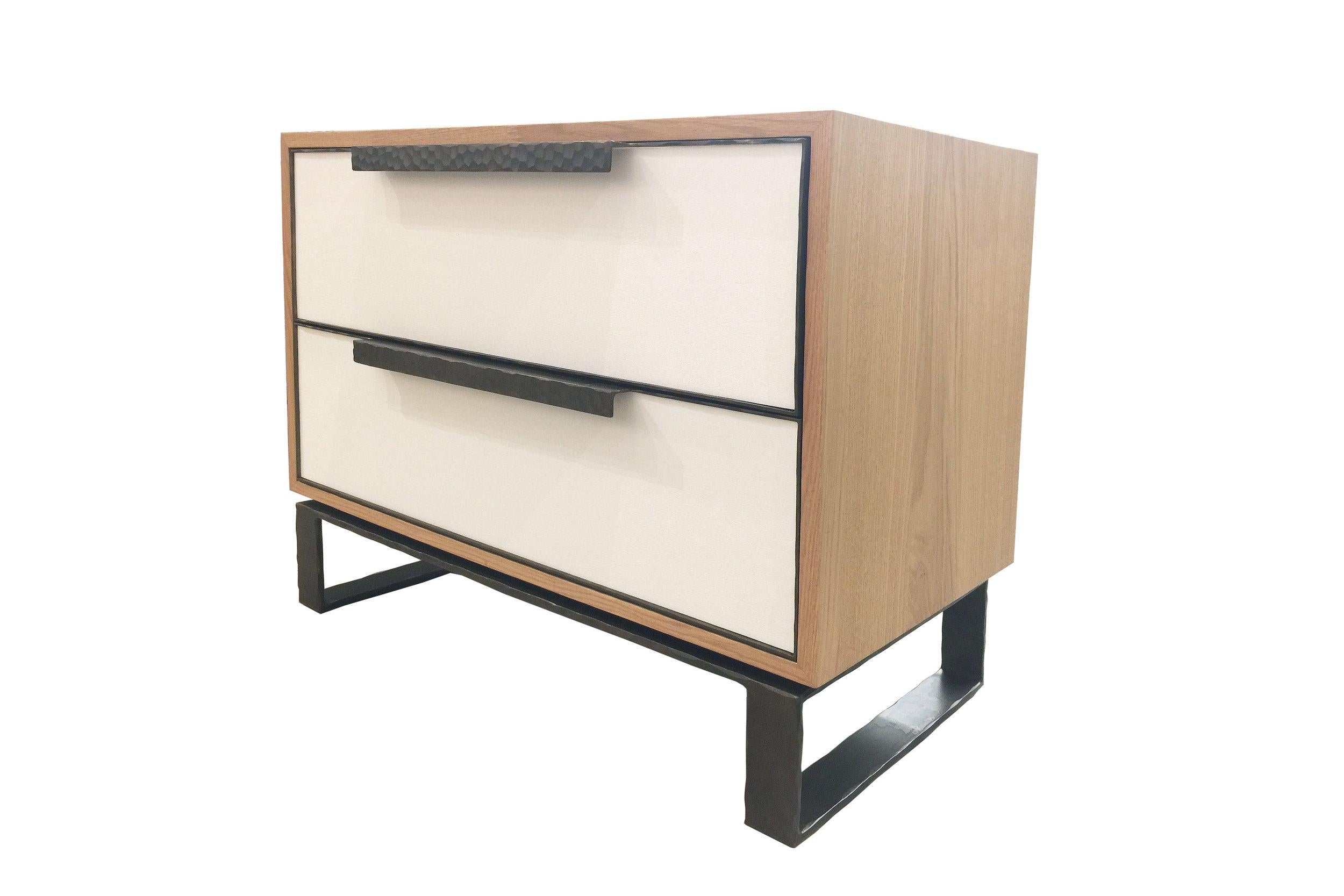 The Chelsea leather nightstand by Ercole Home is a two drawer front with a natural oak finish. Leather decorates the surface with hand-hammered metal framed doors, handles, and base in natural steel metal finish.
Custom sizes and finishes are