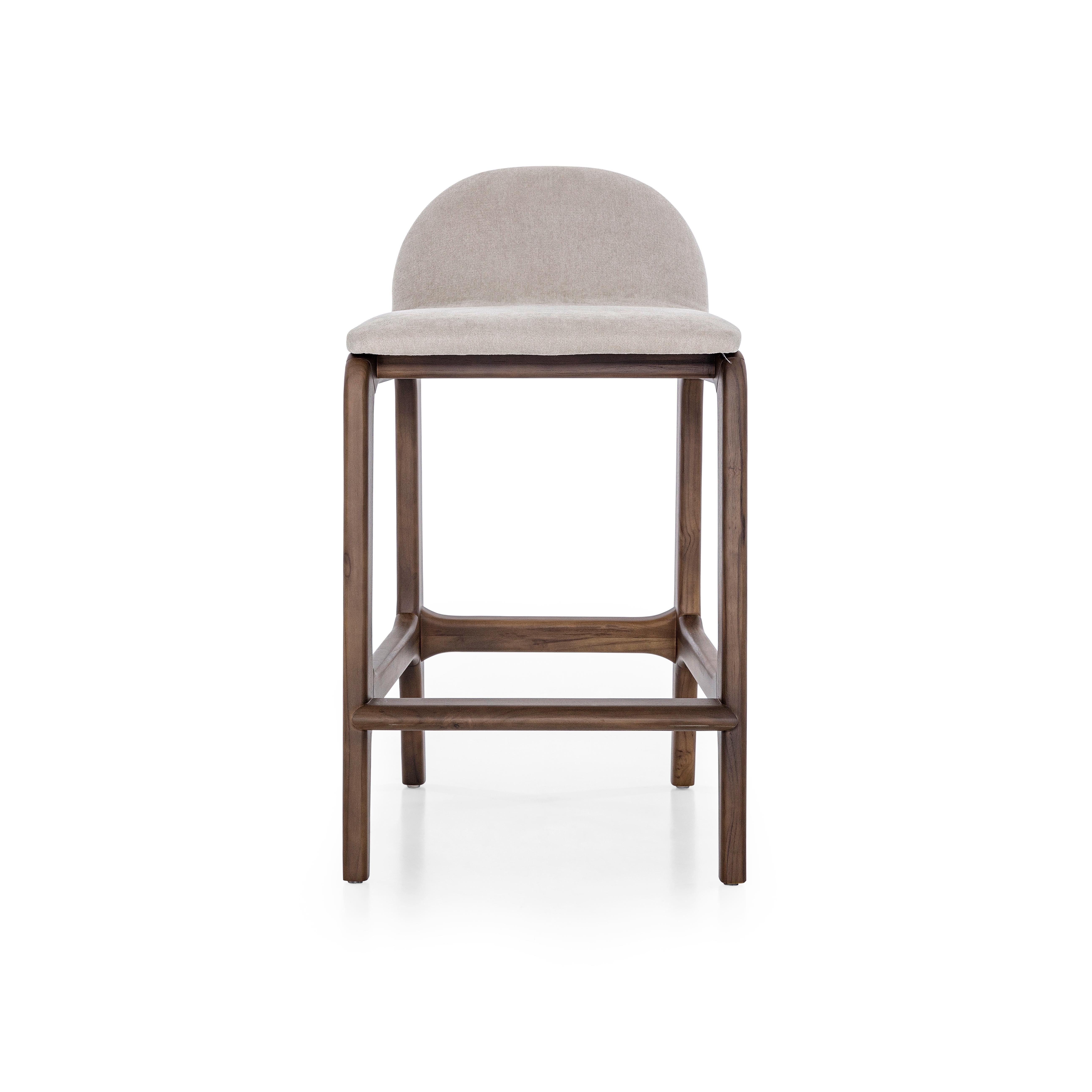 A Ura counter height stool designed by Uultis Studio with walnut finish and beige fabric upholstery. *Please check availability prior to purchase*.

The Ura counter stool showcases a harmonious blend of contemporary design and functional