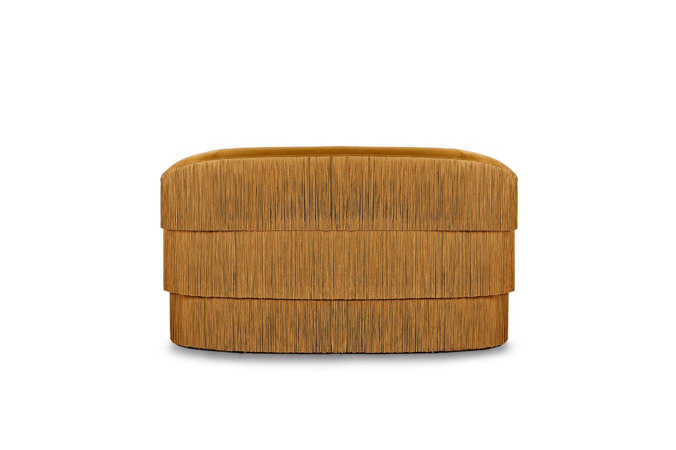 The handmade sofa draws on the signature Franjas fashion theme, ruffling the scene and inviting guests with its fun and flirtatious feel. Featuring three layers of fringes that run along the front and reverse of the wide seat, set against a curved