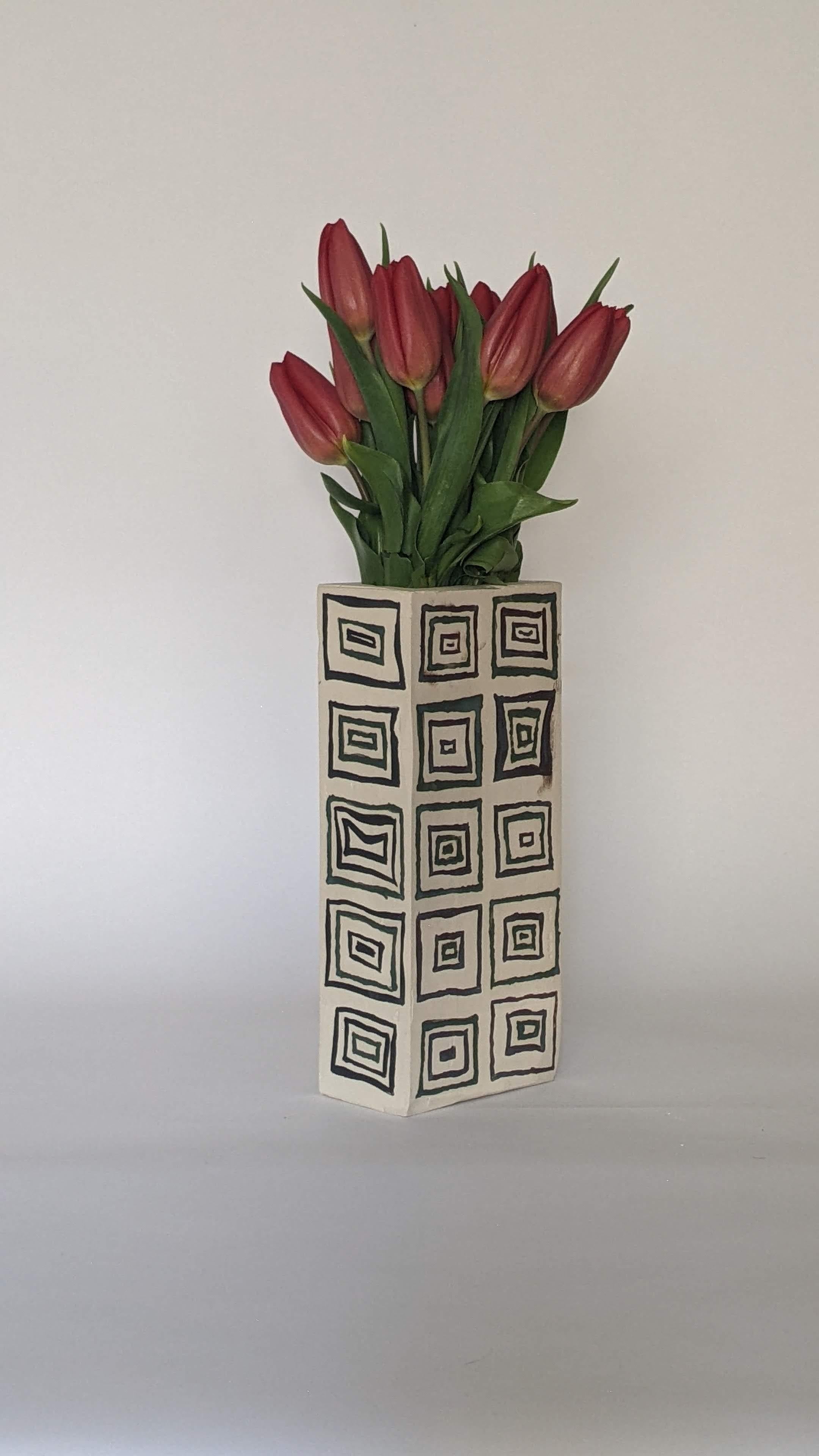 This meticulously crafted hand-painted and hand-glazed glazed ceramic vase design features a sleek modern rectangle hollow brick form painted with an array of hand-drawn and hand-painted rectangles. openings. Each vase is individually slip-cast,