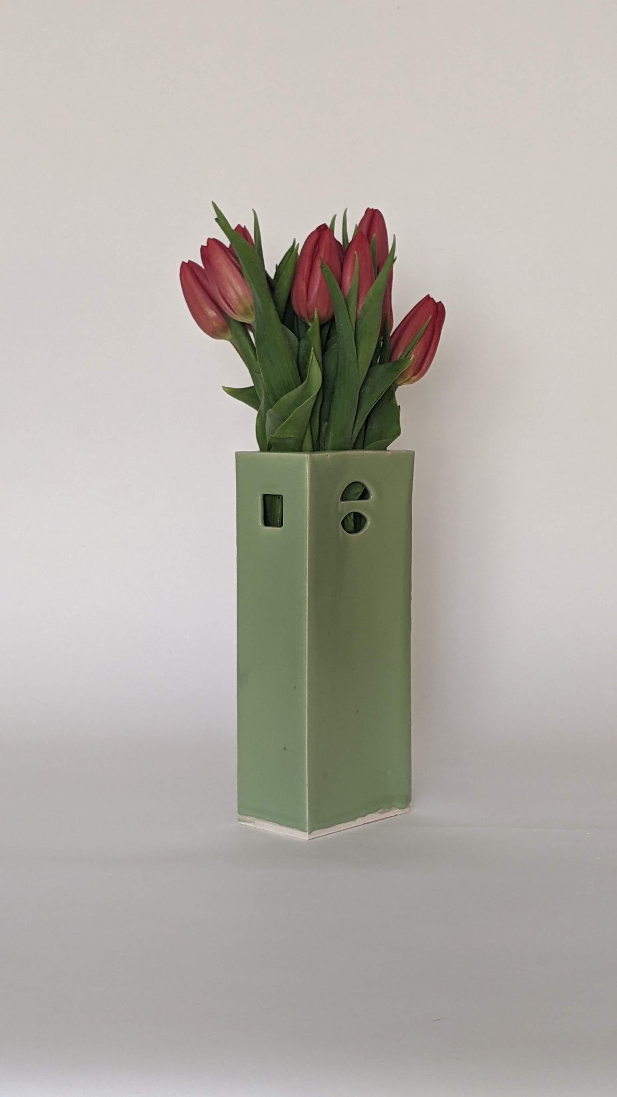 This meticulously crafted glazed ceramic vase is skillfully handcrafted by James Hicks. The design features a sleek modern rectangle hollow brick form with openings inspired by the architectural elements of Louis Kahn's iconic buildings for the