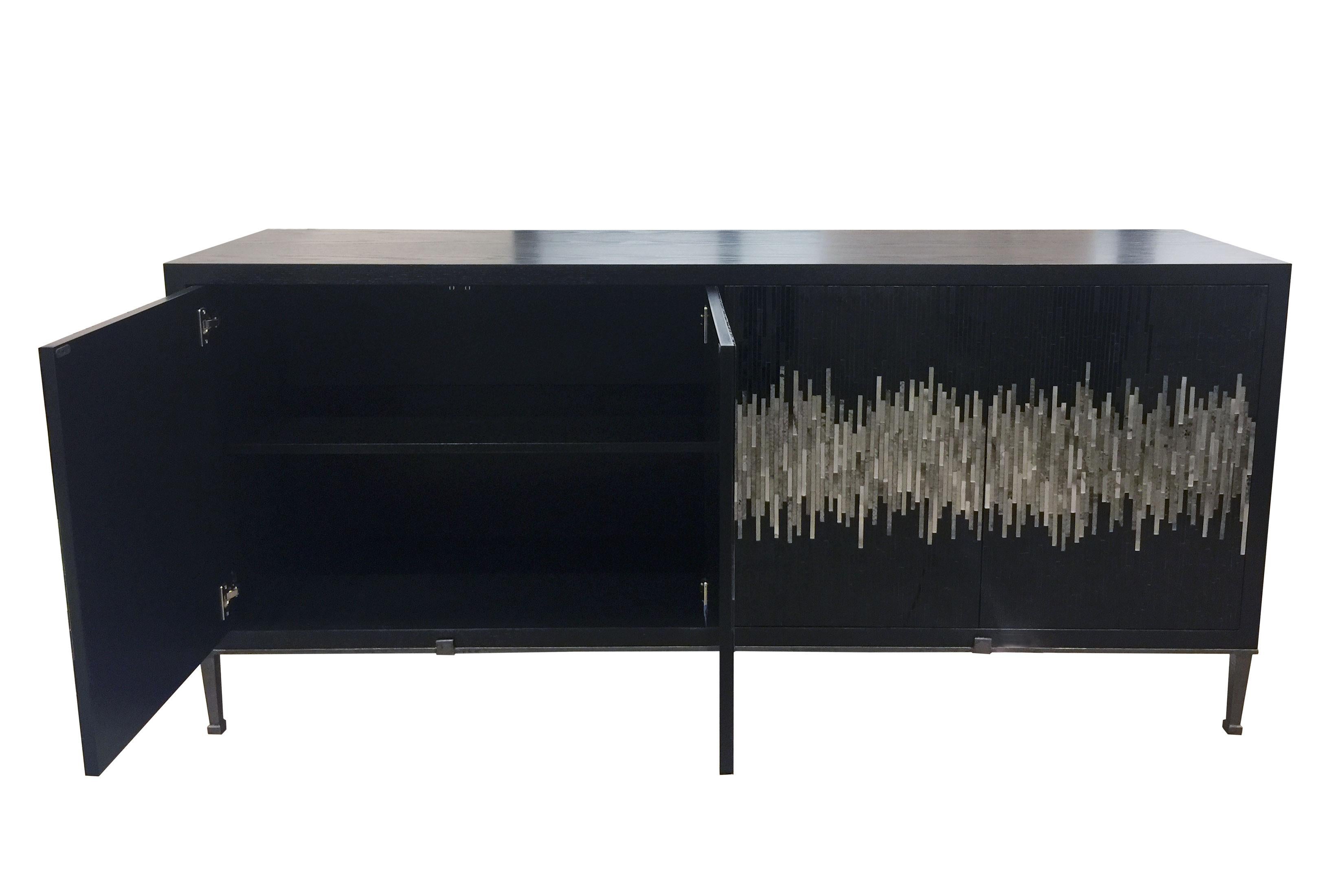 The industrial buffet by Ercole Home has a 4-door front, with Wenge (Black) wood finish on oak. Handcut glass mosaics in black, pewter, and silver decorate the surface in a continuous wave pattern.
The metal Milano base with small decorative tabs