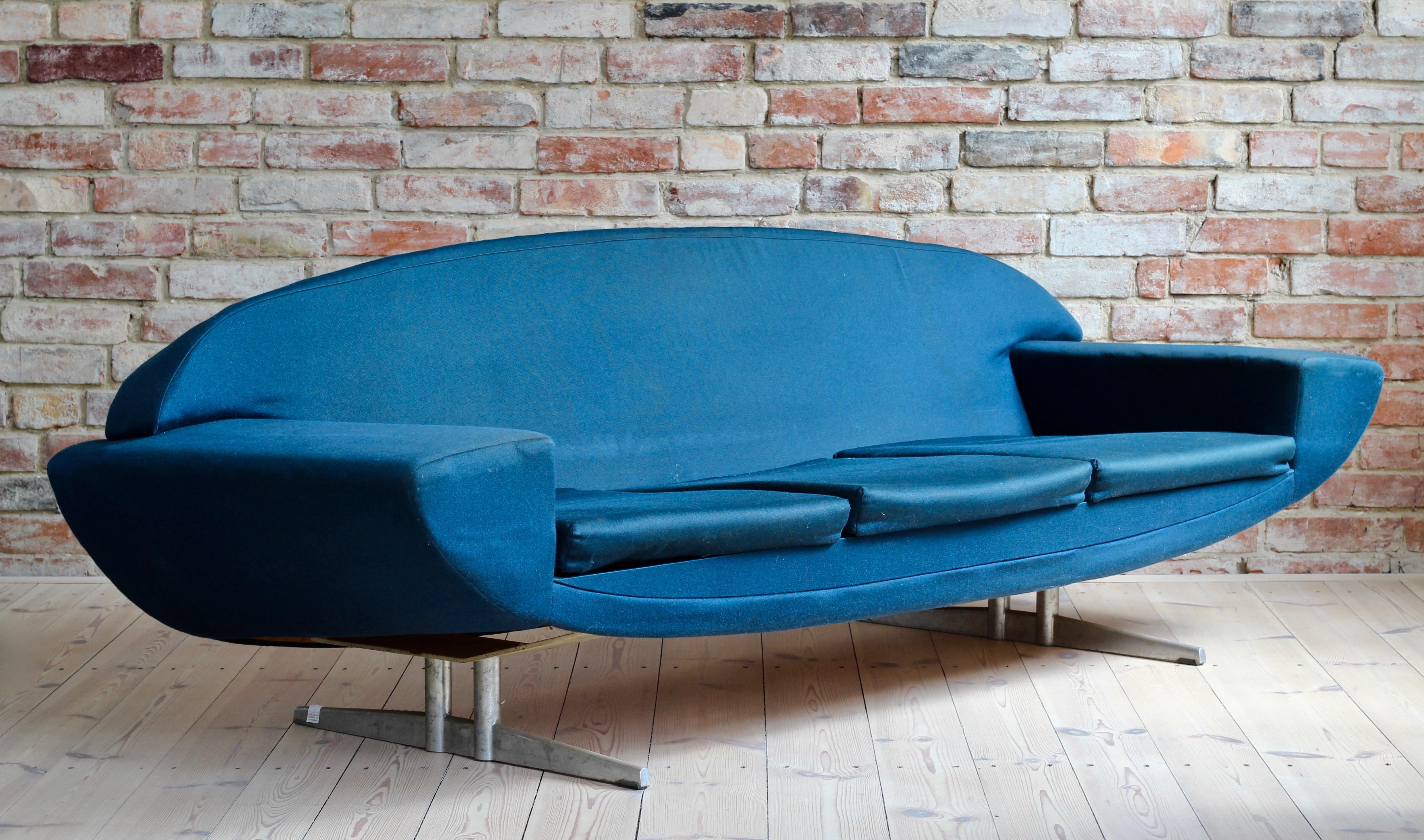 This is an iconic piece of Danish design that is part of the prestigious Capri series by Johannes Andersen for Trensum. Solid metal base and beautifully shaped seating (height 37 cm). The sofa can be reupholstered with a fabric of your choice for