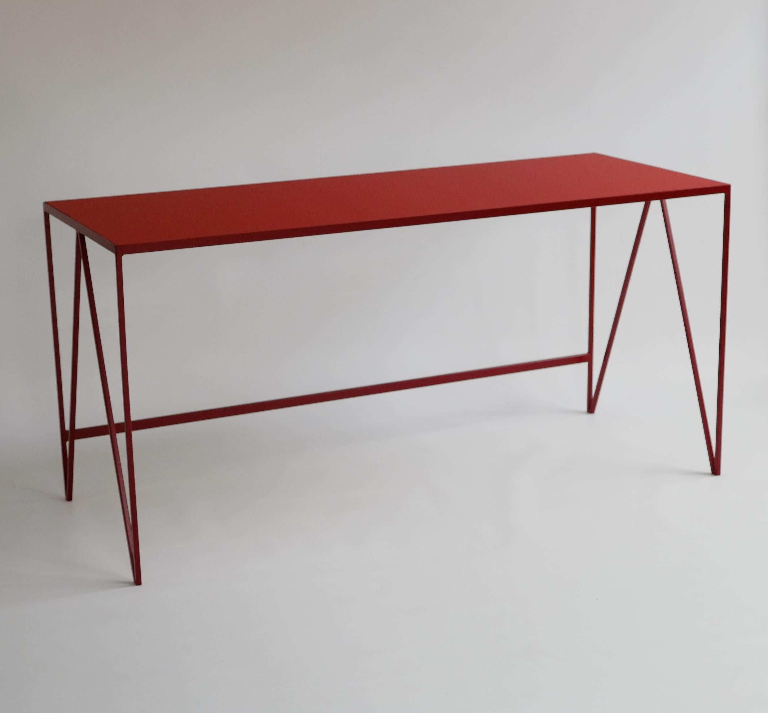 This large study desk is made with a burgundy powder coated steel frame and a deep red linoleum top made from all natural ingredients, such as flax, wood flour and limestone. The furniture linoleum provides a natural satin matt surface with a warm