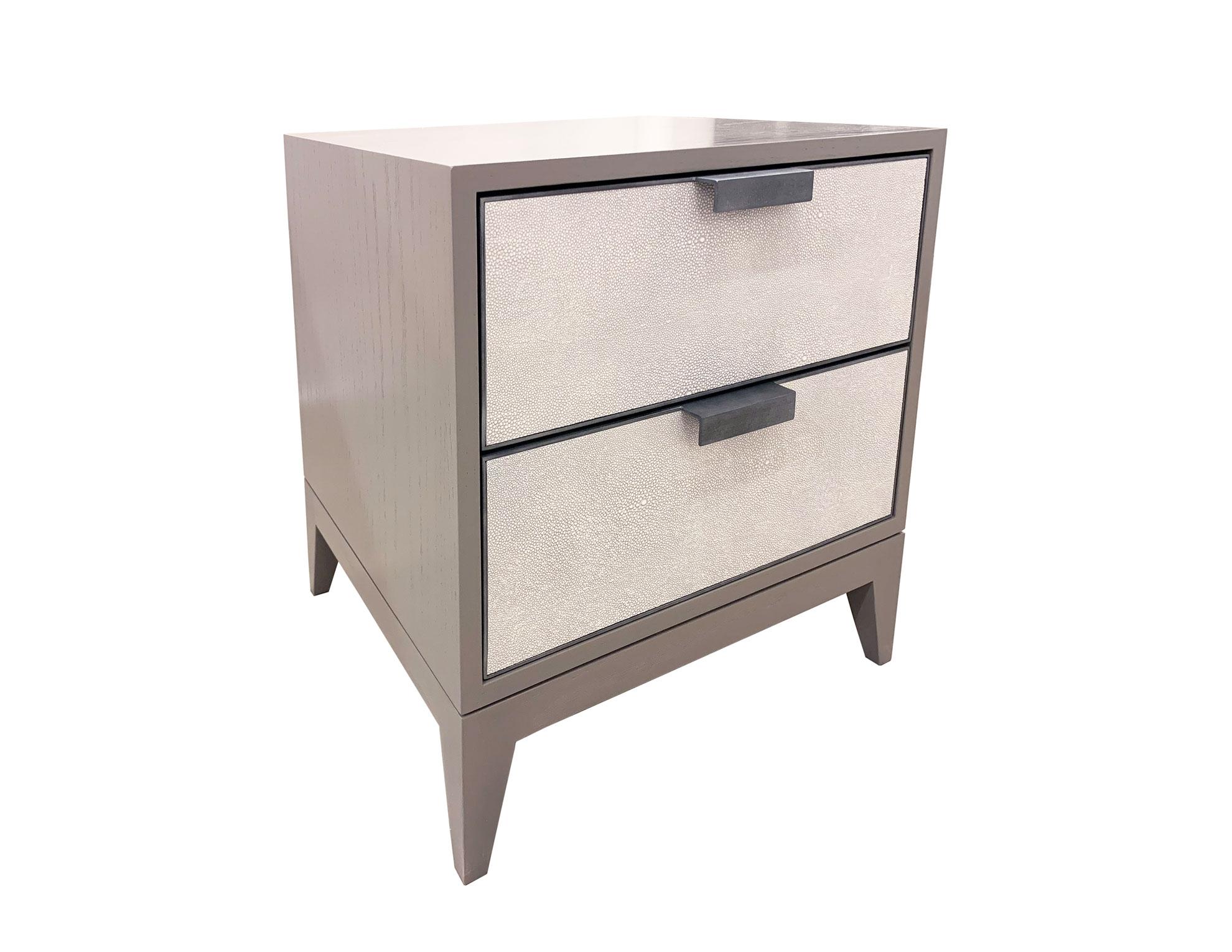 The Milnao Shagreen Leather Nightstand by Ercole home has a 2-door front, with Linen 2 wood finish on oak.
White/ light gray shagreen leather with hand-forged metal frames in pewter patina are on the drawer surface.
Custom sizes and finishes are