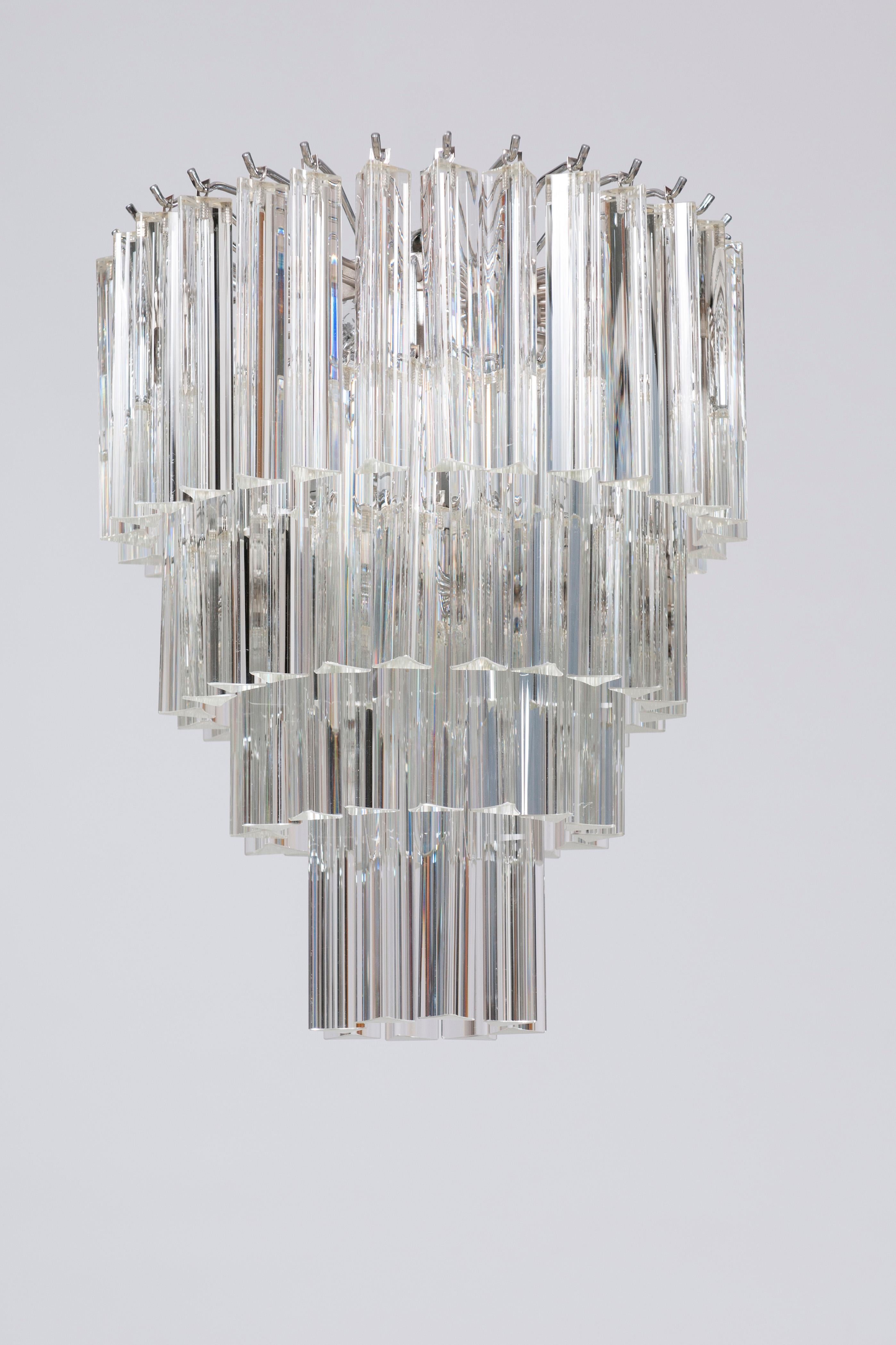 Modern Murano Glass Lighting with clear elements Italy contemporary.
This outstanding chandelier brings within itself a refined touch of Venice, through its elegant shape and its bright lights, the result of the Venetian centuries-old glassmaking