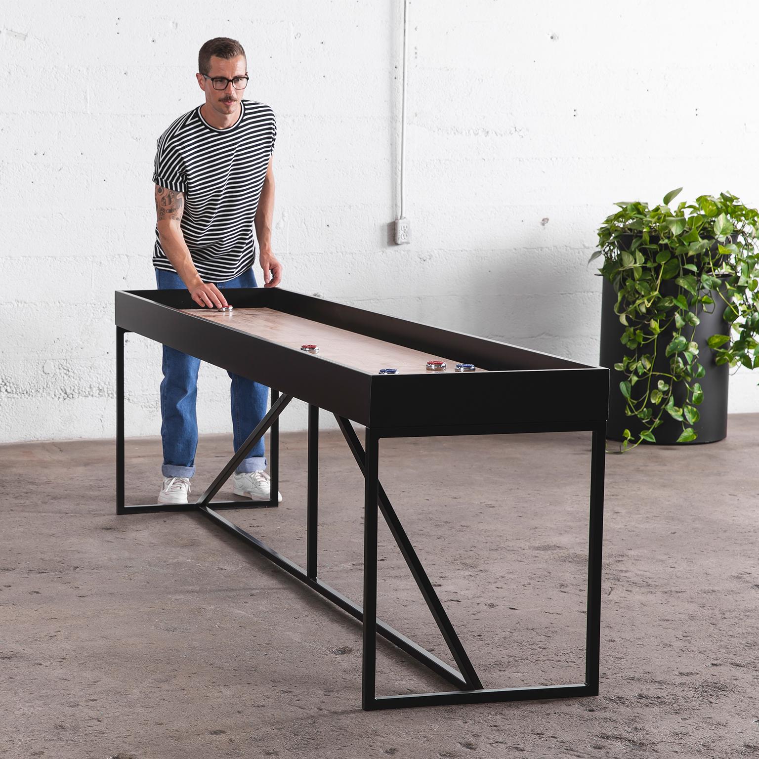 Our modern wooden shuffleboard gives an updated look to a classic game. Each shuffleboard table is made to order in Vancouver, BC. Fitted in a black or white lacquer frame, the natural oak playing surface gives this table distinct character and a