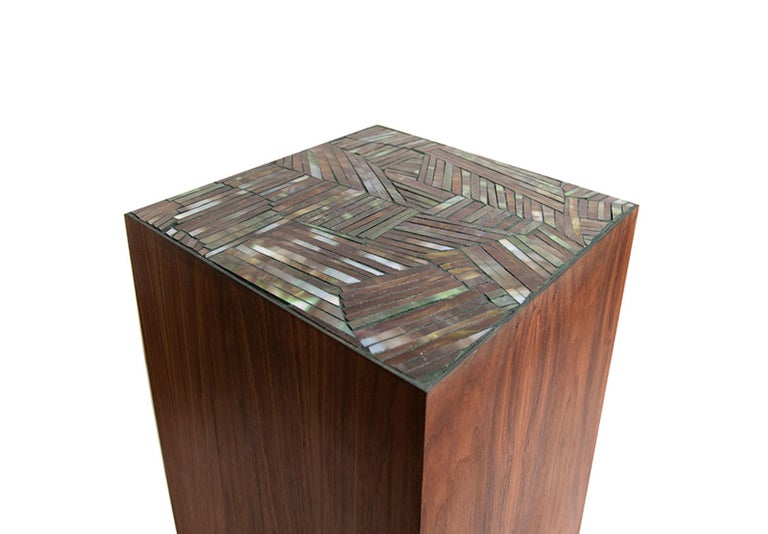 The Natura Pedestal by Ercole Home has a natural wood finish on Walnut. Handcut glass mosaics in Umbria / Dark green glass mosaic decorate the top surface in Facets pattern.
Custom sizes and finishes are available.
Made in New York City.

#pedestal