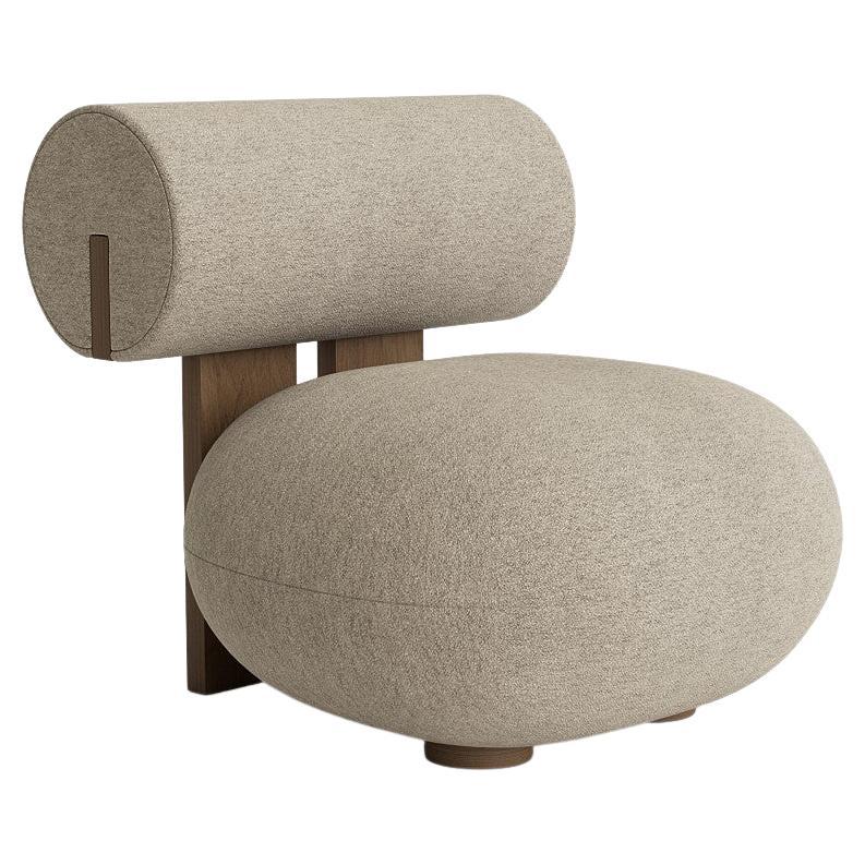 Soft, playful shapes characterise this family of upholstered pieces, the Hippo makes a stylish statement in any interior setting. The Hippo Chair stands on two sturdy legs and a wooden profile connecting the seat and back which in stark contrast to