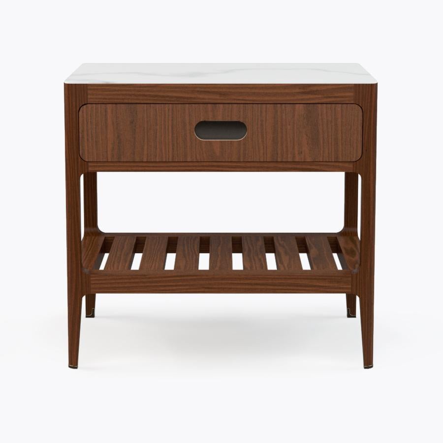 This walnut side table or nightstand designed and fabricated by Munson Furniture draws inspiration from midcentury designs and fits beautifully with both traditional and contemporary interiors. We've started with our signature table design and added