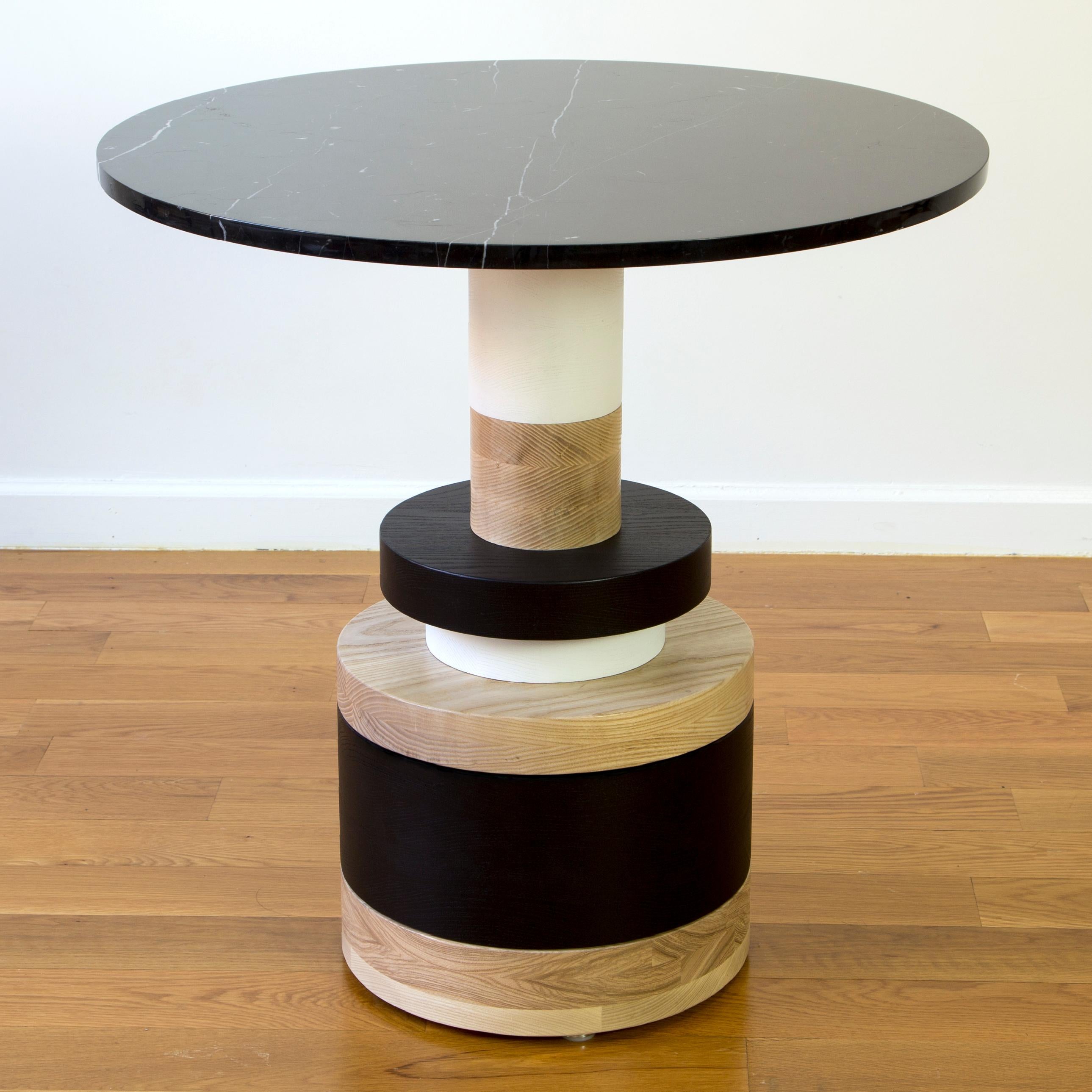 The Sottsass-inspired “Sass Dining Table” is a bold, graphic statement piece. A honed Carrara marble top sits on an Amish-made base composed of painted and stacked wood circles. Made to order.

The version as shown is 30