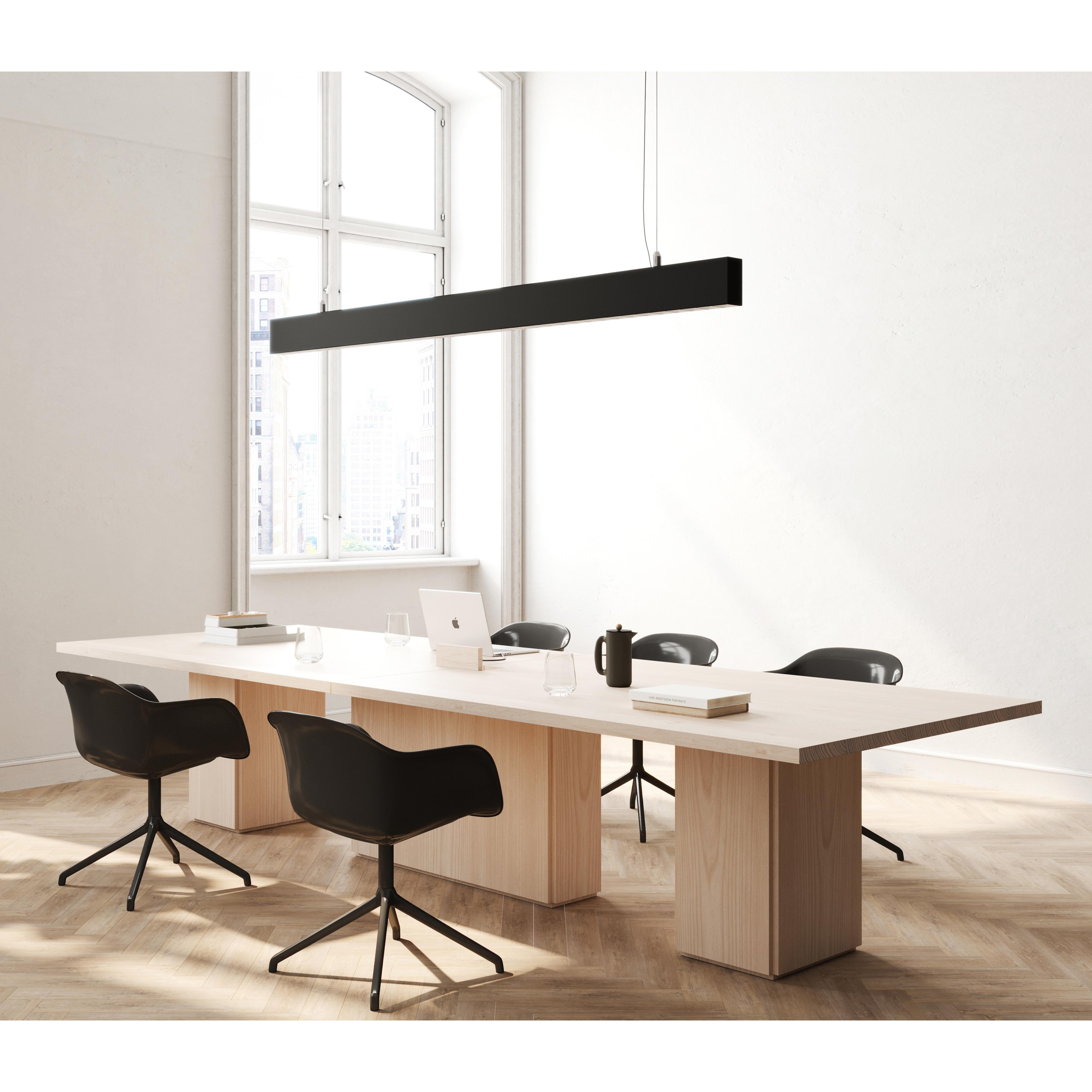 The slab conference table has an architectural silhouette in workspaces, adding dimension without detracting from the overall aesthetic. 

This simple table’s geometric form encompasses a solid wood rectangular top balanced atop two to three