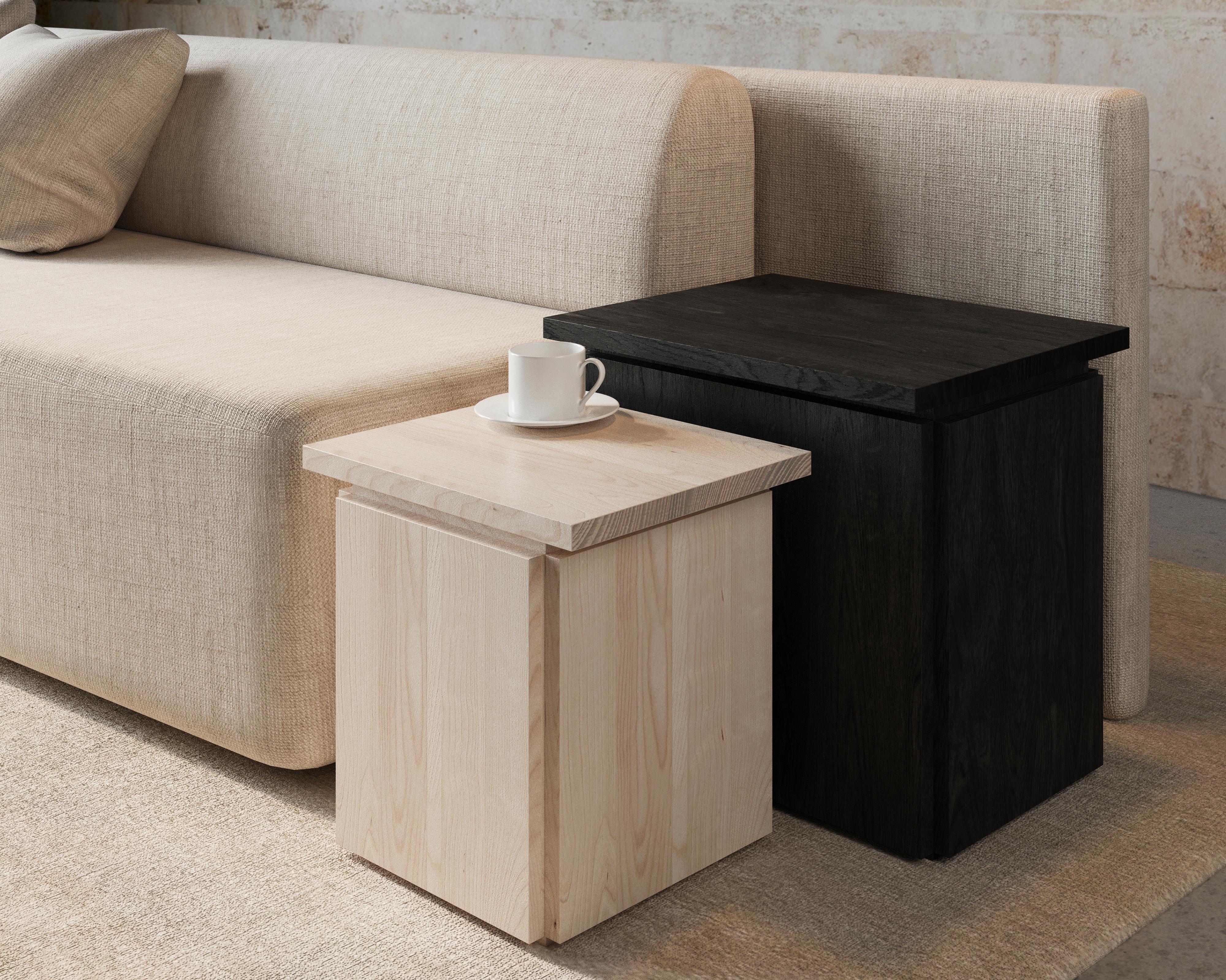 The slab side table showcases a geometric shapes and clean lines.

A simple plinth base and floating top emphasize the organic richness of the wood surfaces. The wood brings warmth to the modern silhouette and the offset corners create depth. This