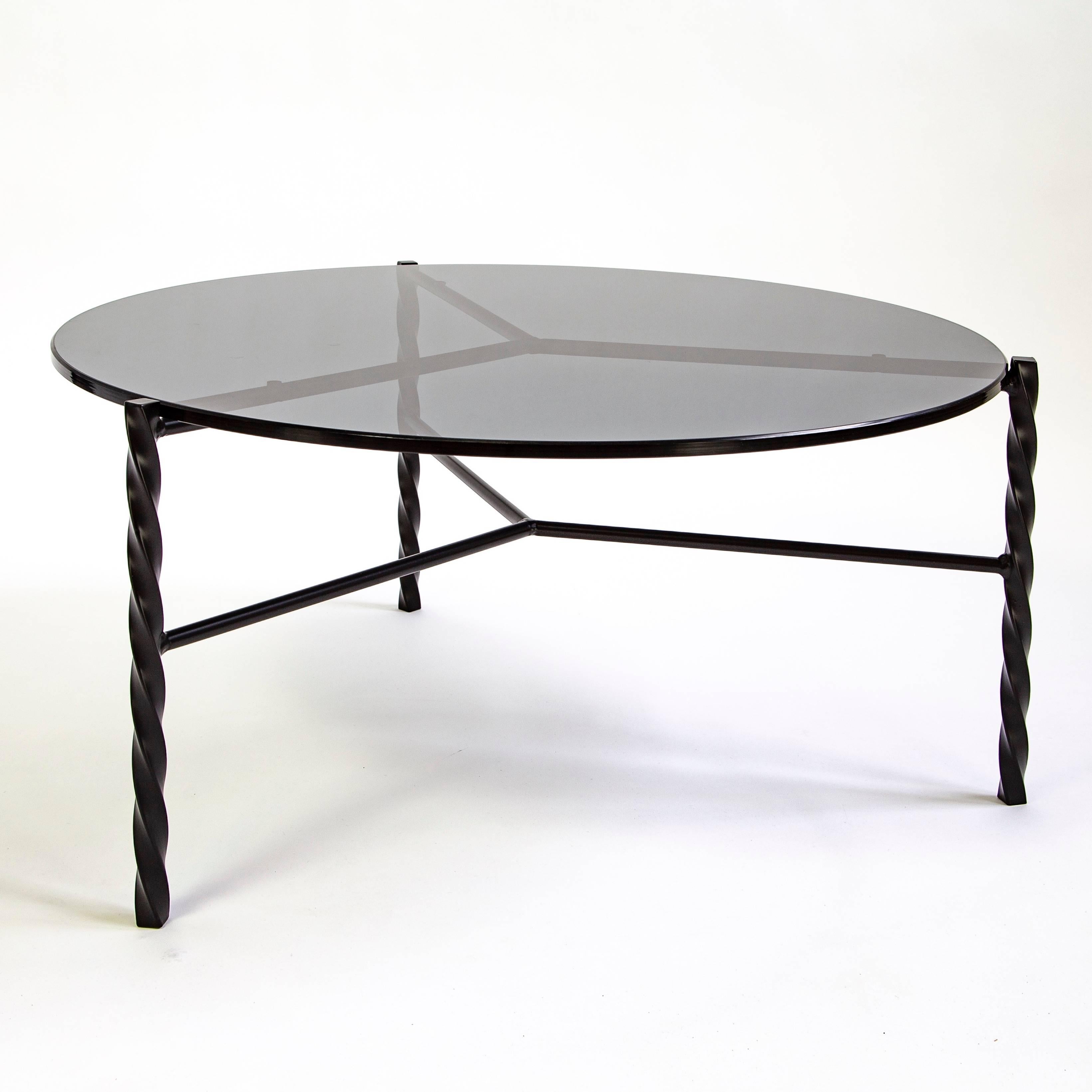 This piece is a floor model that was used at a trade show for a few days. It's in great condition with a few minor scratches .

The Von Iron series consists of coffee and side tables with a distinctive twist. Inspired by traditional blacksmith