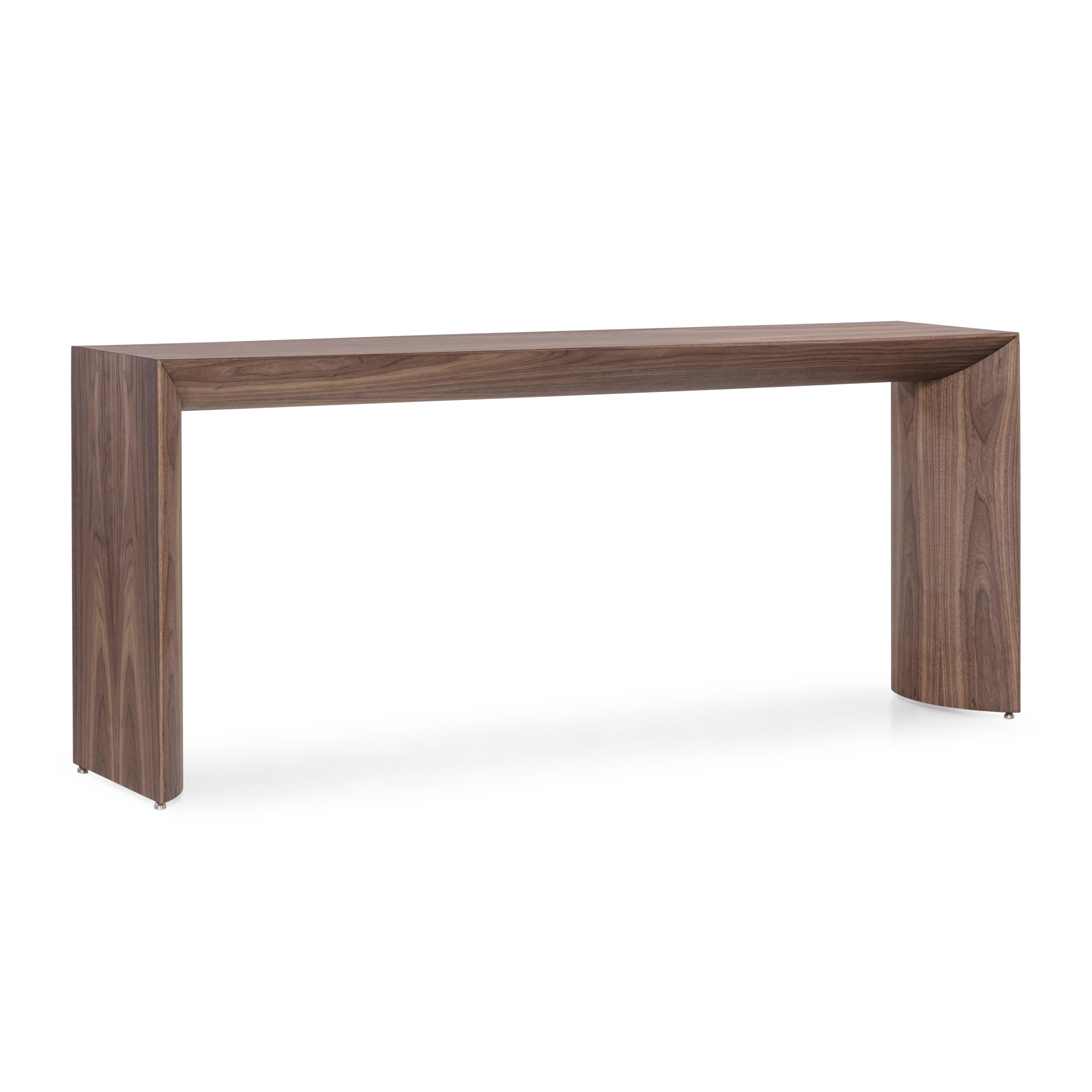 A Gugge console table designed by Studio + A! with walnut veneer, 71-Inch top and minimalist design. *Please check availability prior to purchase*.

The Gugge console table, crafted with a walnut veneer, embodies a minimalist yet striking design