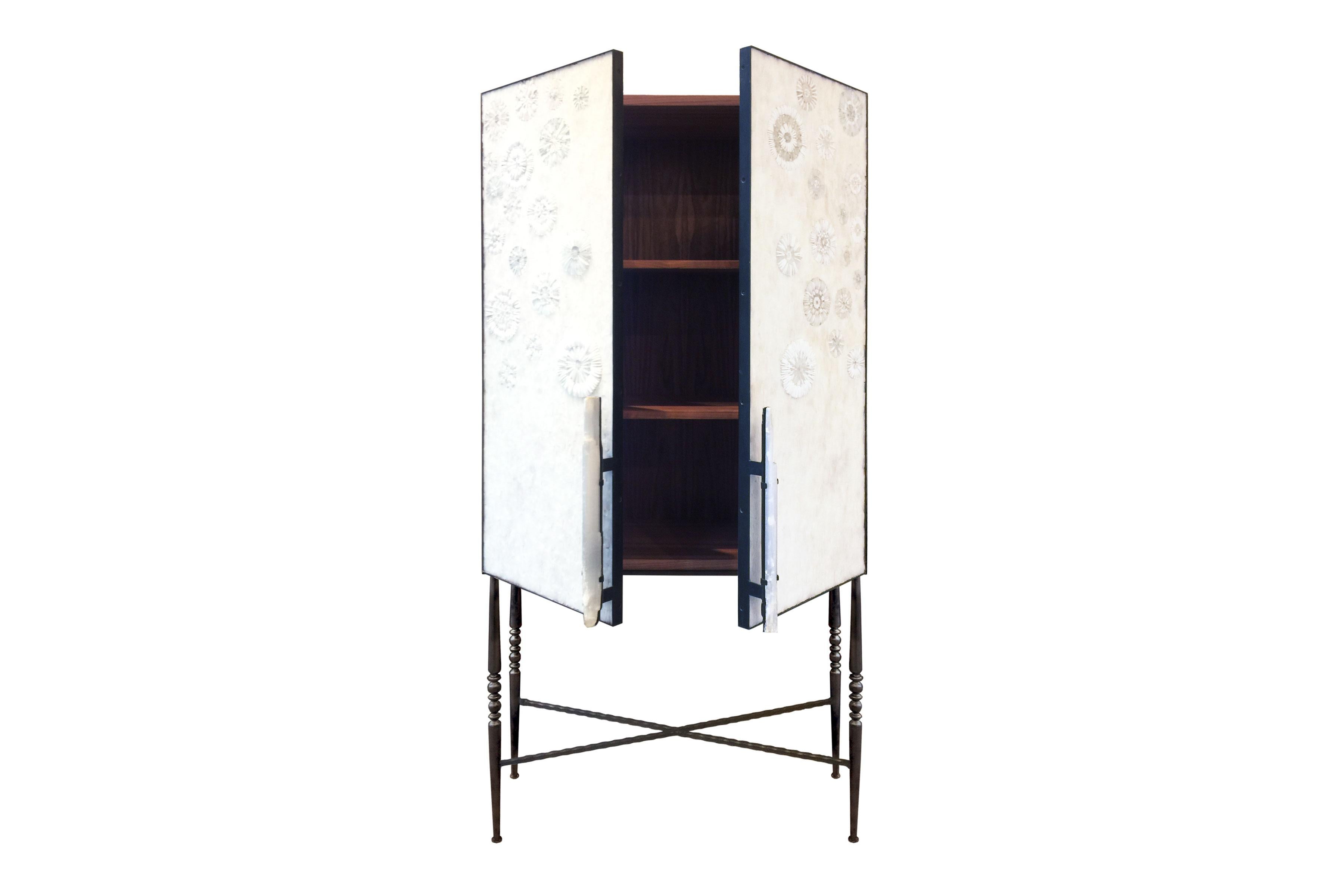 The Blossom bar cabinet by Ercole Home has a 2-door front, with natural wood finish on walnut.
Handcut glass mosaic in variety shades of white and ivory decorate the surface in Blossom and shards mosaic patterns.
Doors and selenite handles are