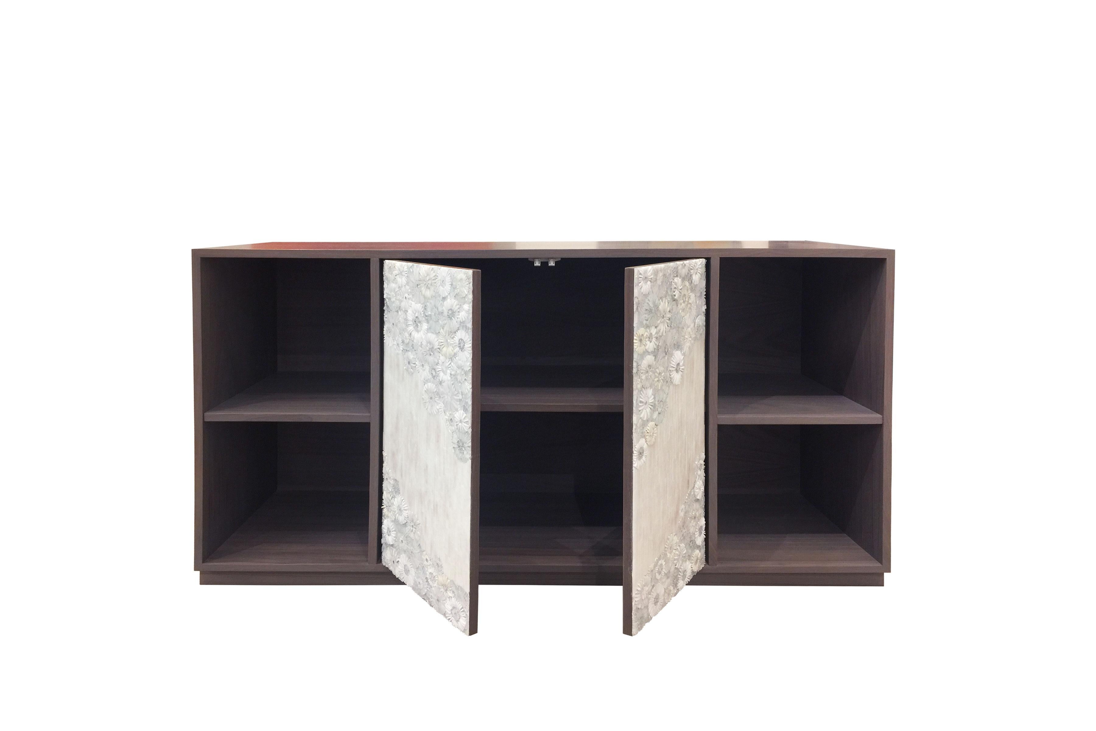 The Blossom buffet by Ercole Home has 2-door front and 2-open shelves, with gray stain wood finish on American black walnut.
Handcut glass mosaic in variety shades of white and ivory decorate the surface in Blossom and stipe mosaic pattern.
2'' h