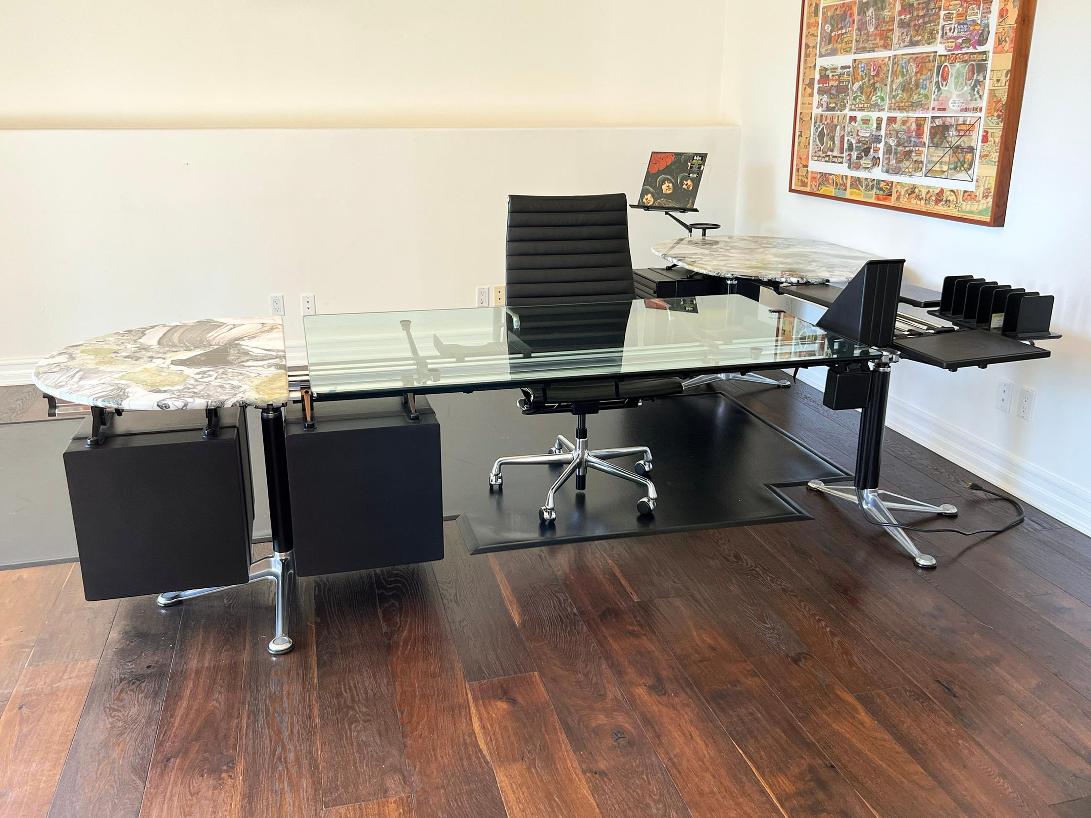 Step into a new era of workspace elegance with this custom Bruce Burdick desk system, a masterpiece of innovation, style, and craftsmanship that embodies the legacy of modern design. Shaped in a striking L-configuration, this iconic desk measures a
