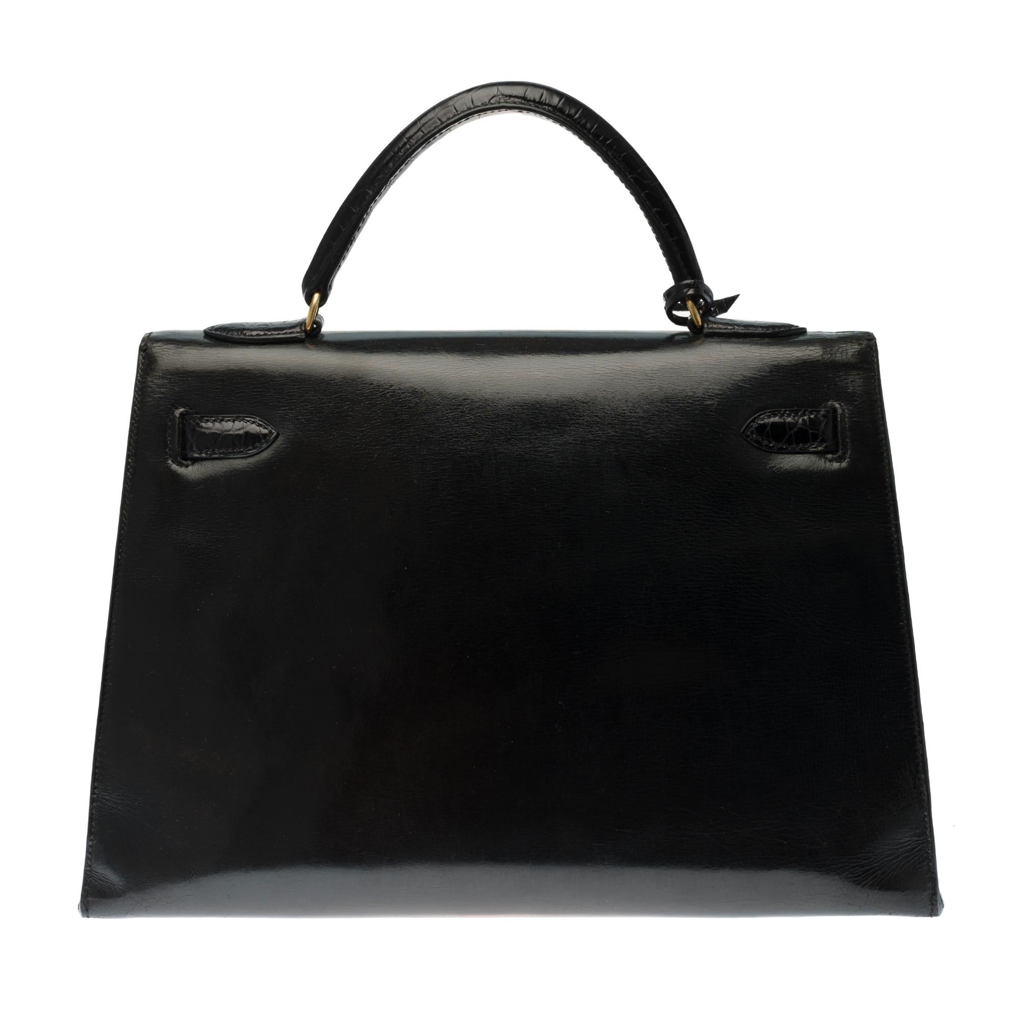 Hermès Kelly 32 turned over black leather box bag customized with two superb black Porosus crocodile bands on the flap, strap added in black crocodile (not signed), fasteners and clasp in gold-plated metal, handle in new black leather box, new black