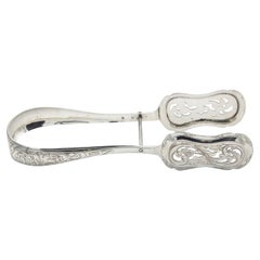 Cut and embossed silver tongs for bread or salads