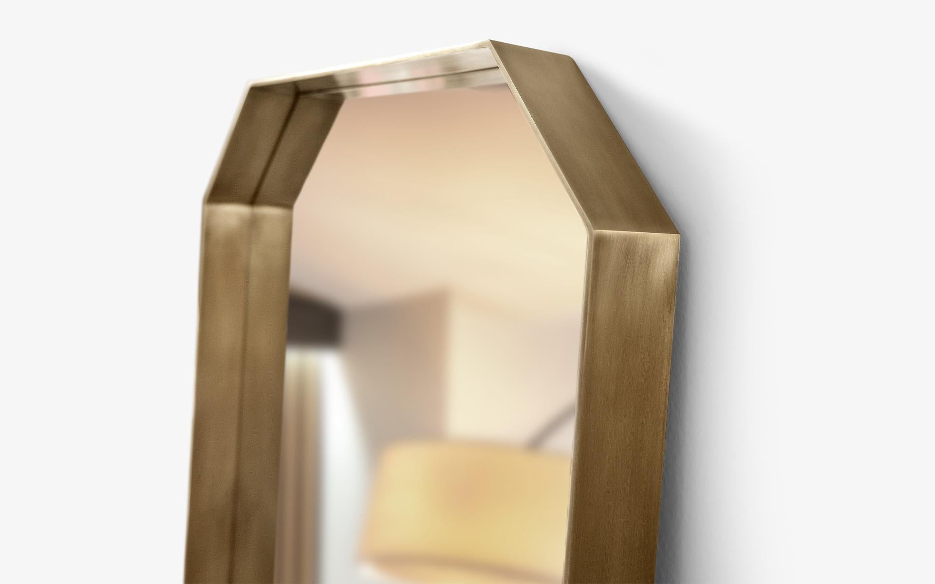Cut full length mirror distinguishes itself from standard rectangular mirrors by adding a unique touch to its design with its sharp corners. The sharp edges create a balanced and symmetrical aesthetic, while the warm undertones of brass add a