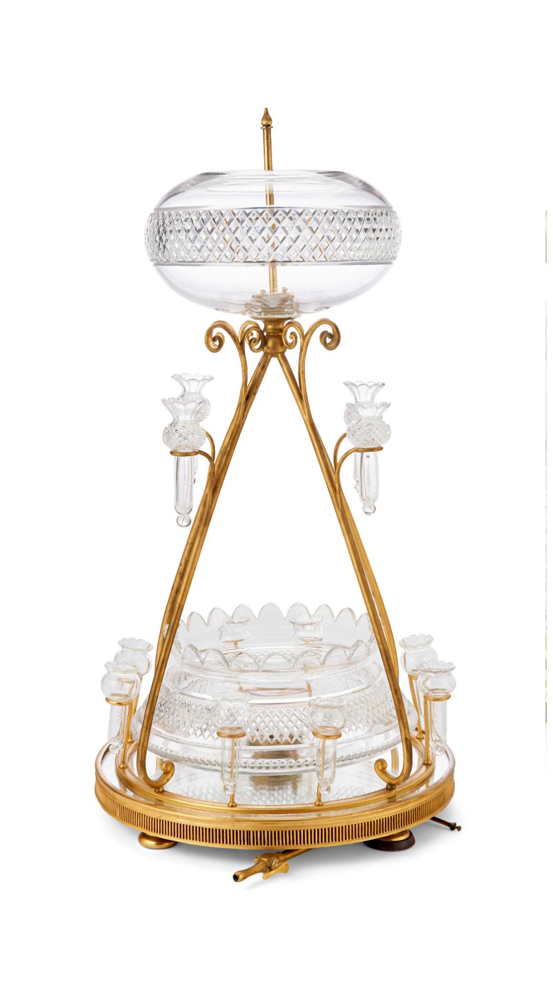 Our cut-crystal and gilt bronze fountain comes from the widely admired glass maker, F. & C. Osler of Birmingham, circa 1885. This rare and unique fountain is comprised of an upper reservoir and lower bowl of cut crystal with serrated edges and