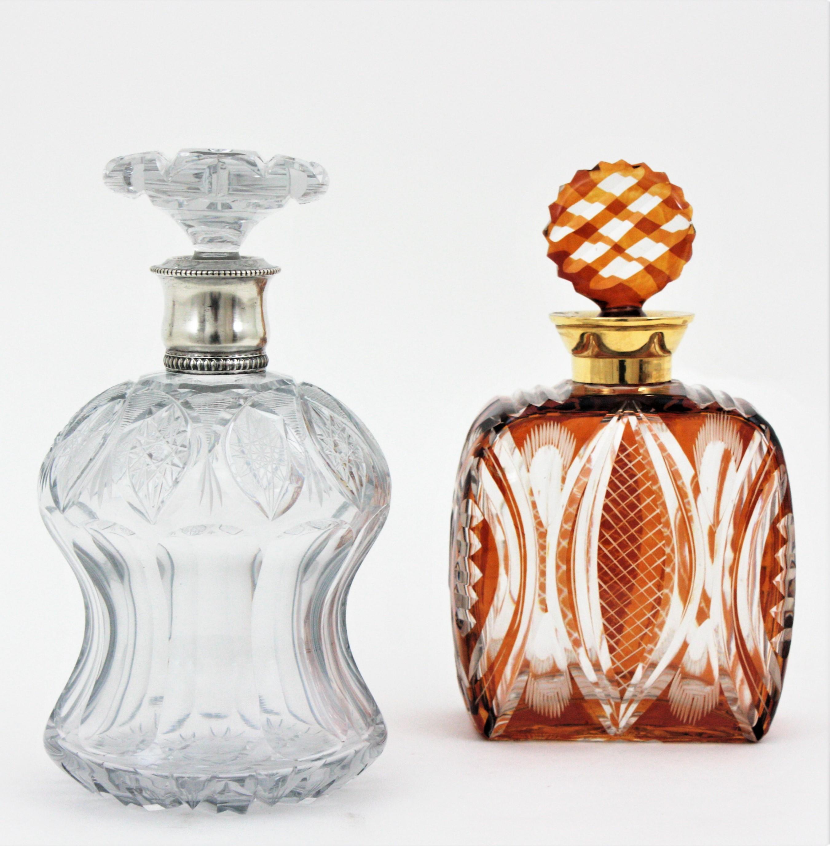 Unmatching pair of Art Deco cut crystal and silver decanters with stoppers. Spain, 1930s
Beautiful set of a cut crystal amber drinks decanter and a clear cut crystal one. 
Each one has a different design and stoppers in different shape. Eye-catching