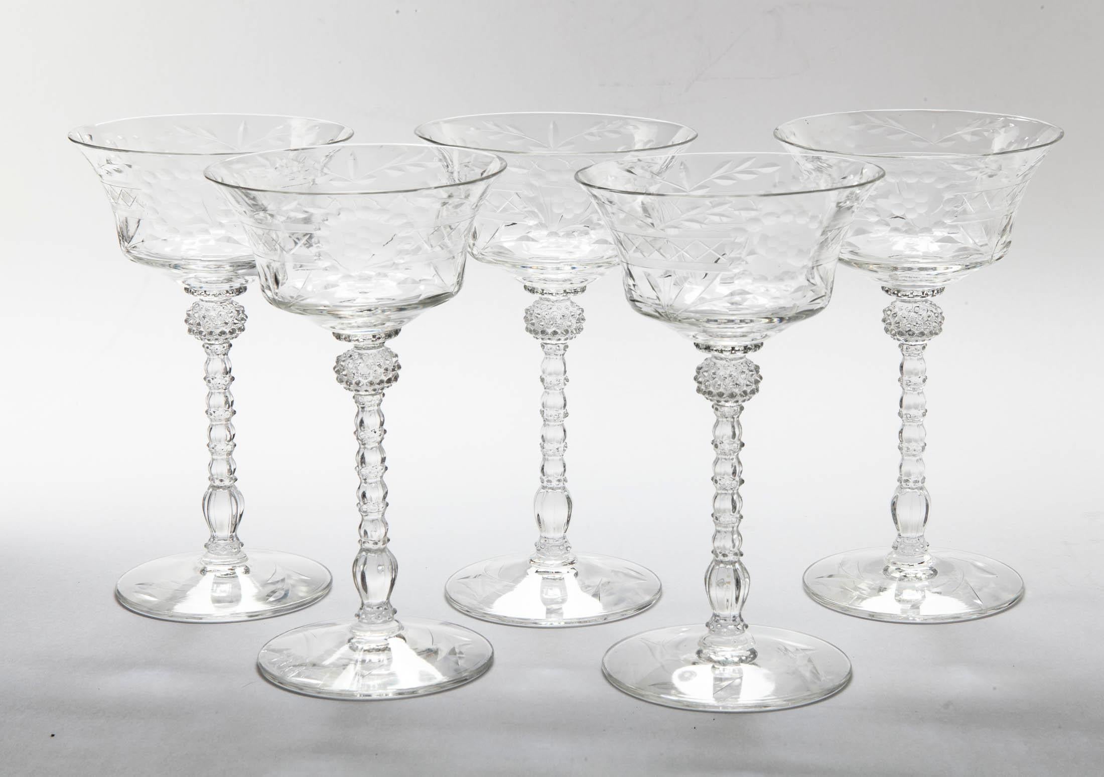 Intricately cut crystal champagne coupes with blown glass stems.