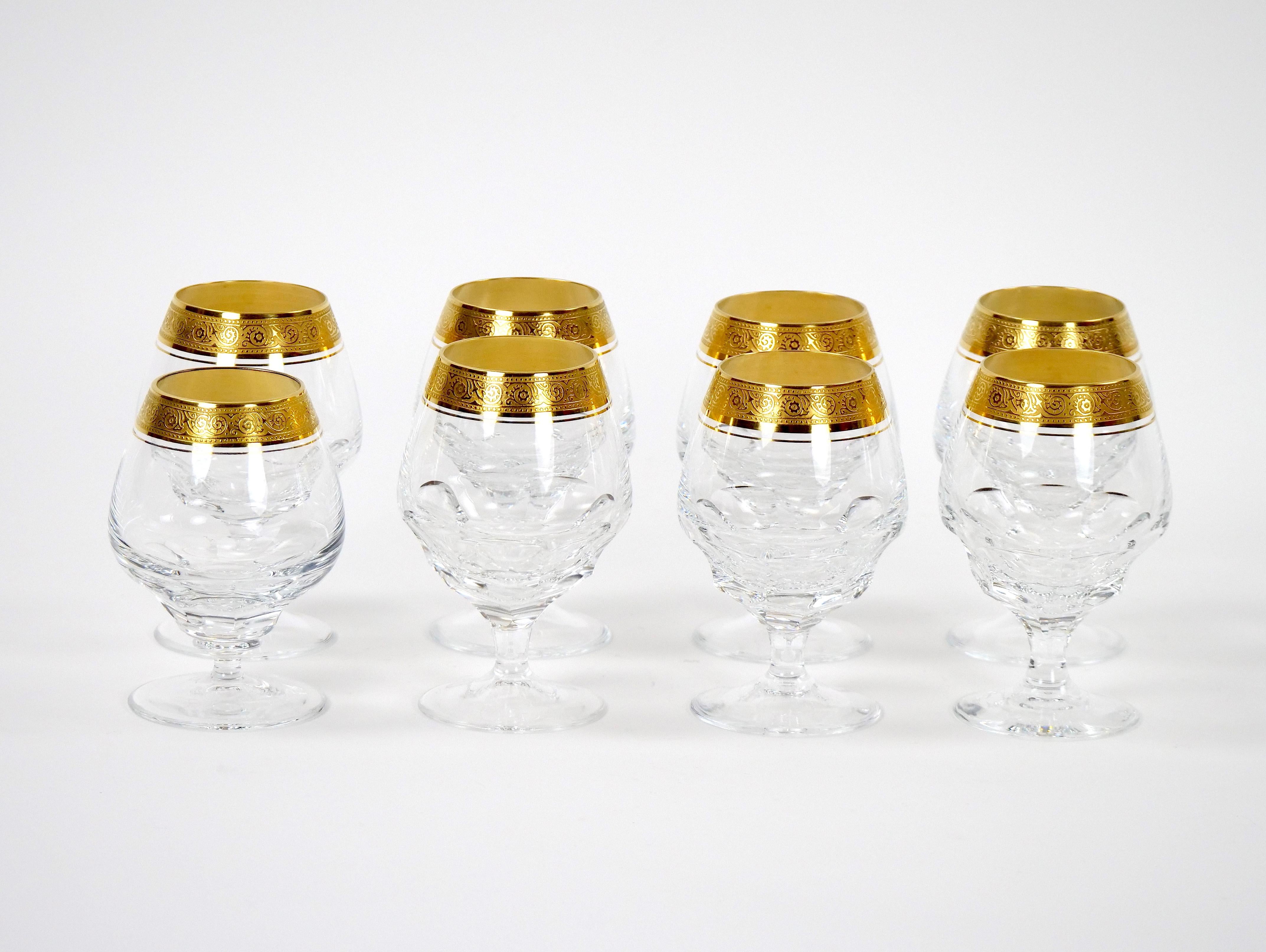 Elevate your dining experience with our exquisite cut crystal snifter set, meticulously designed with double trimmings of gleaming gilt gold. This opulent service for eight people brings sophistication to any occasion, combining intricate