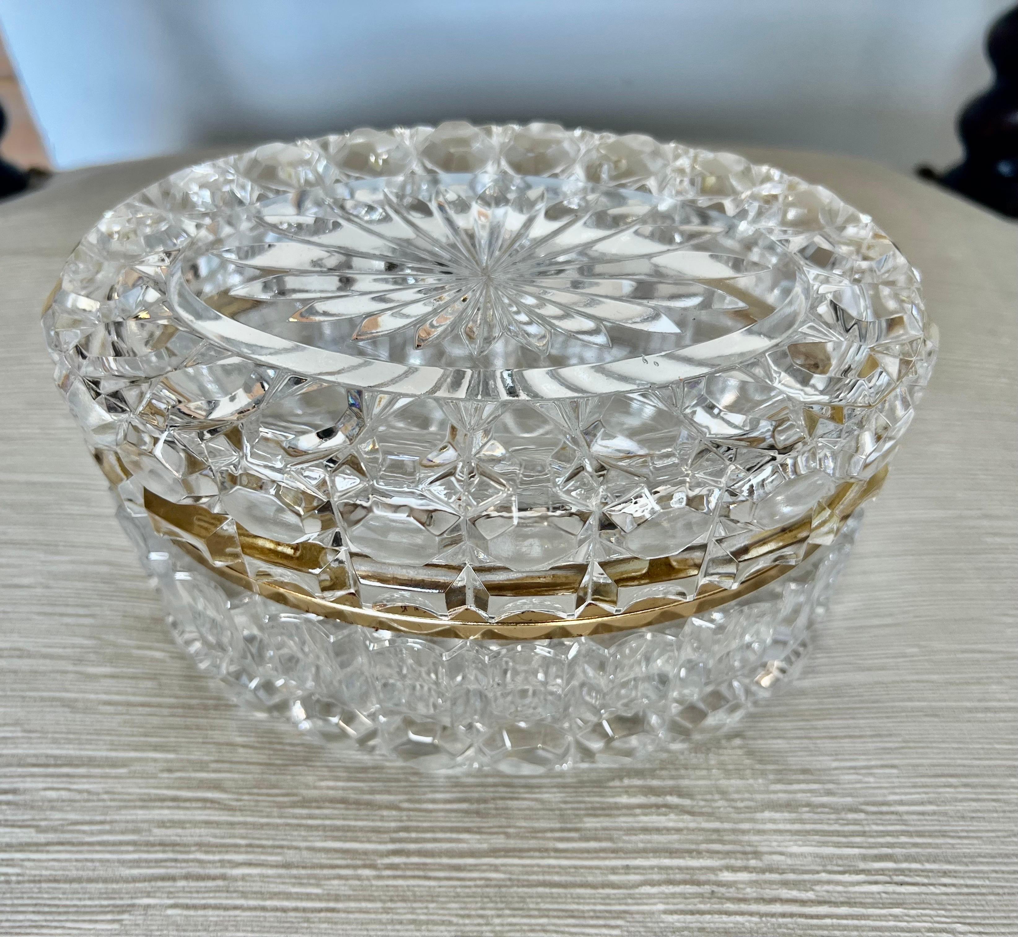 Oval shaped early 20th century French cut crystal jewelry box with brass rim.