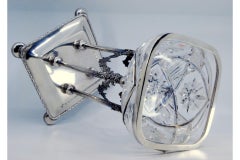 Cut crystal fruit bowl with silver frame on four flower-covered pillars