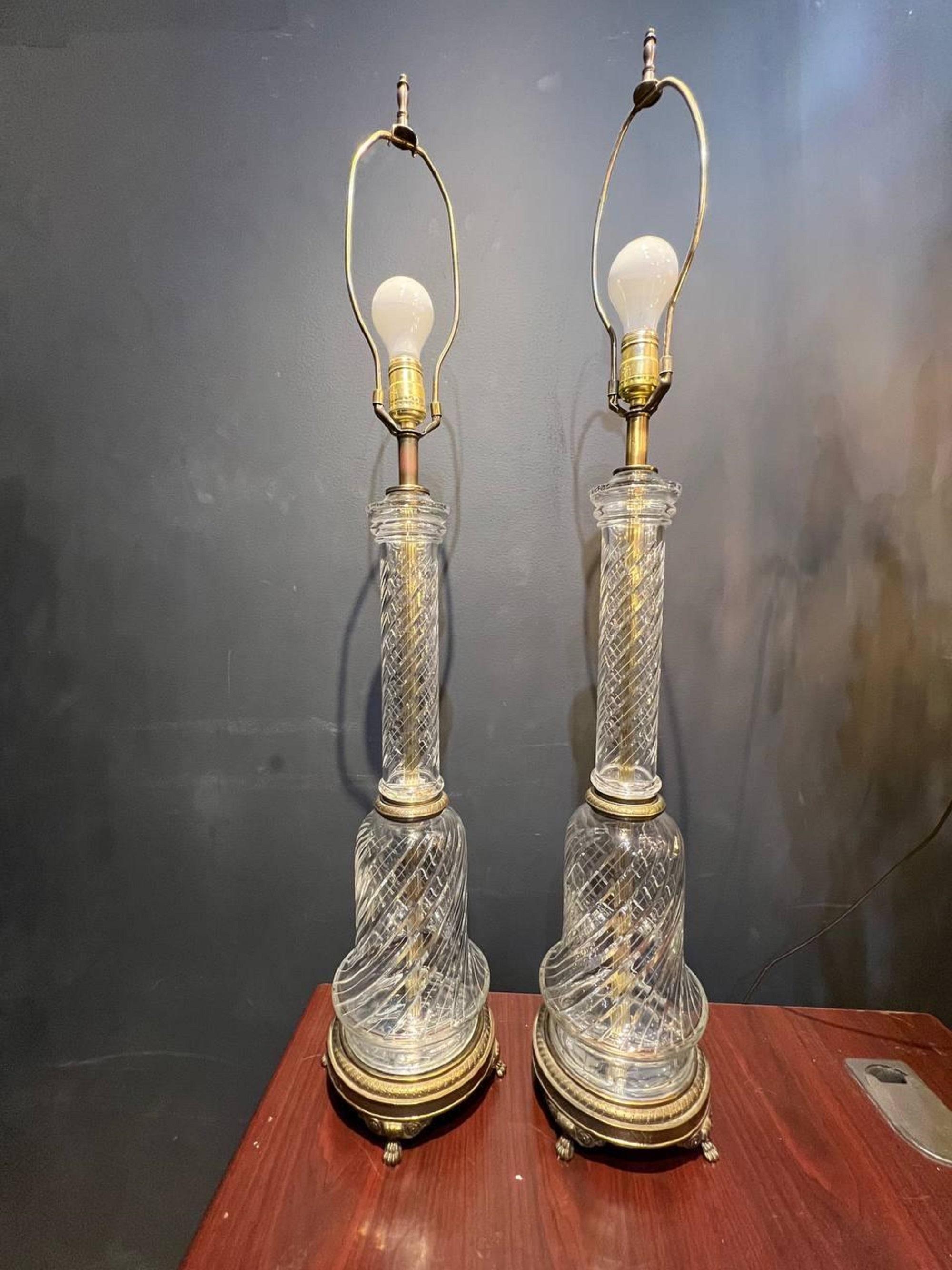 A pair of circa 1940s cut crystal table lamps with brass bases.

Dealer: G302YP.