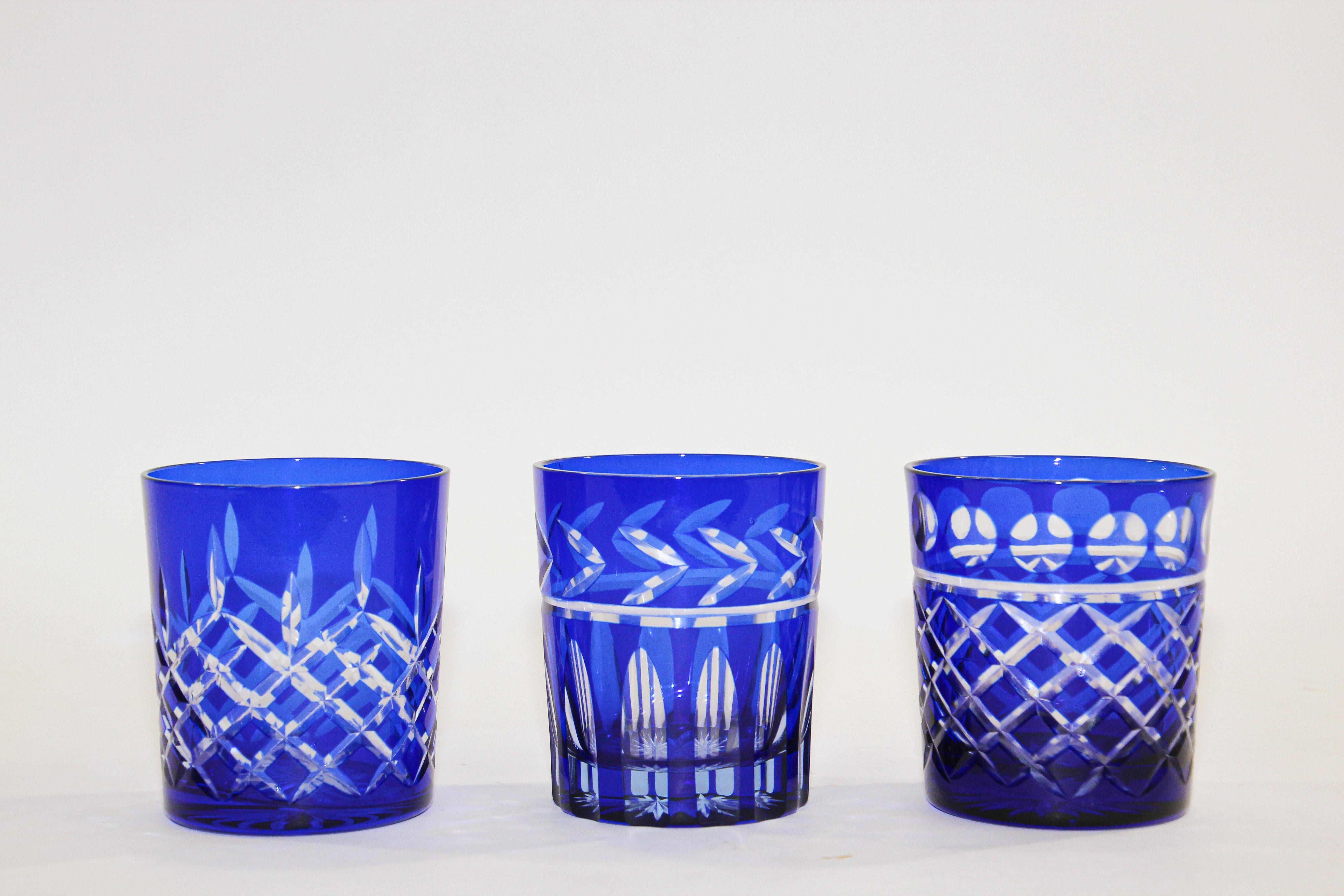 Set of three whiskey glasses tumbler cobalt blue crystal Baccarat style. 
The vibrant hand blown rich sapphire blue jewel sapphire blue crystal glass is cut to clear to reveal a lovely pattern with clean lines. 
Set of 3 rock whiskey or water