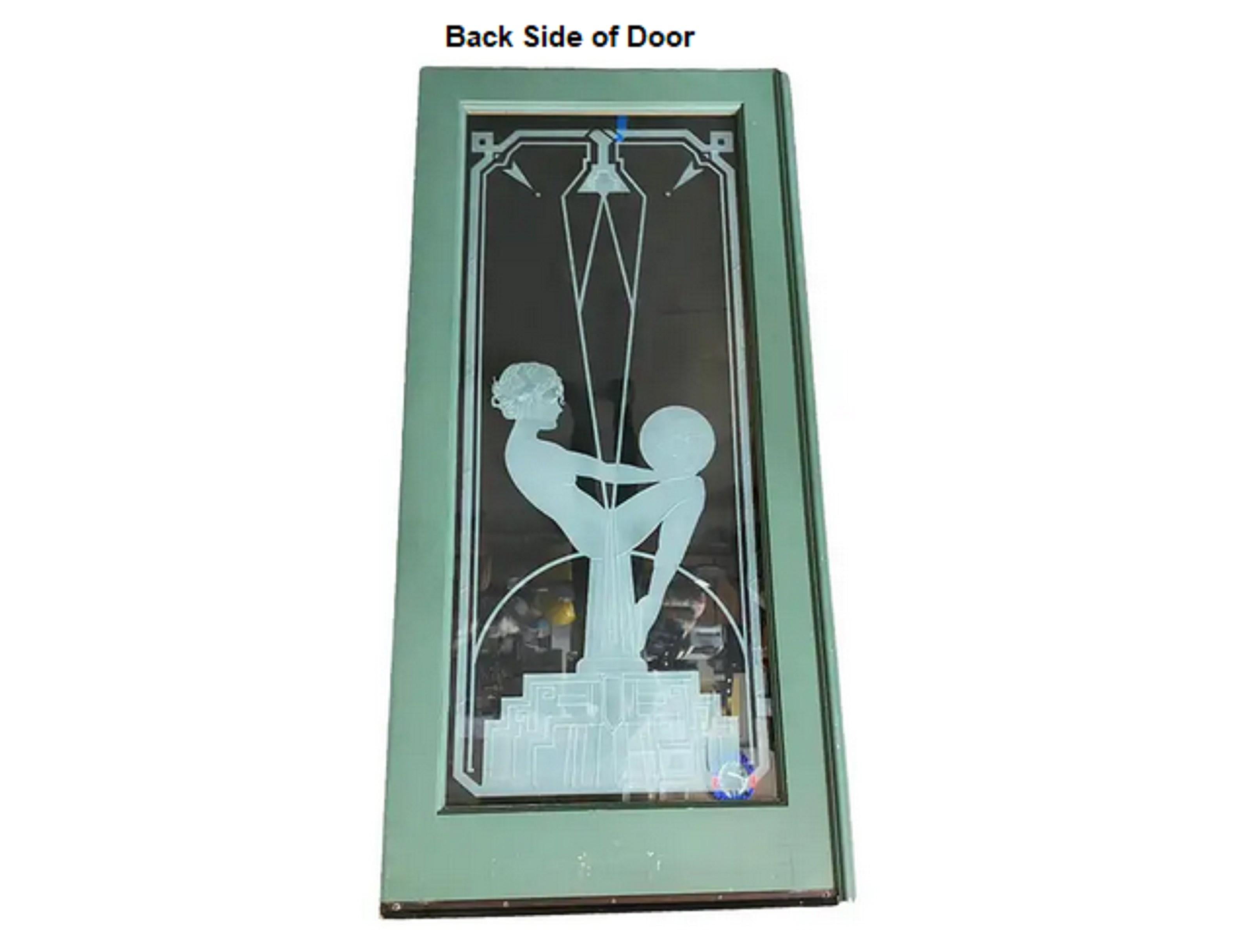 Custom-made hand-etched/cut art glass door, featuring a nude flapper girl sitting on a stepped art deco obelisk modeled after the famous Biba statues of the 1920s. The custom glass pane is fixed to oak door frames and features relive cut 1/2