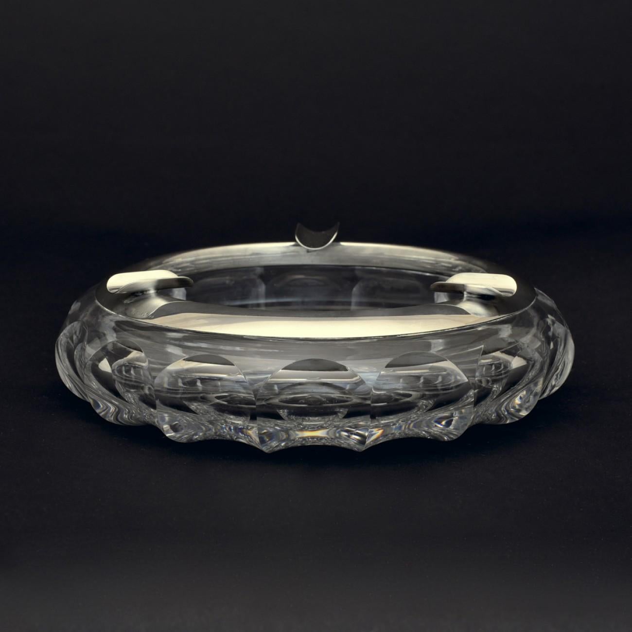 Cut crystal cigar ashtray with Sterling silver collar that has three rests for cigars; circa 1925. Stamped with silver marks of the Imperial crown and crescent moon for Germany and a purity stamp of 925 (the same purity of British sterling