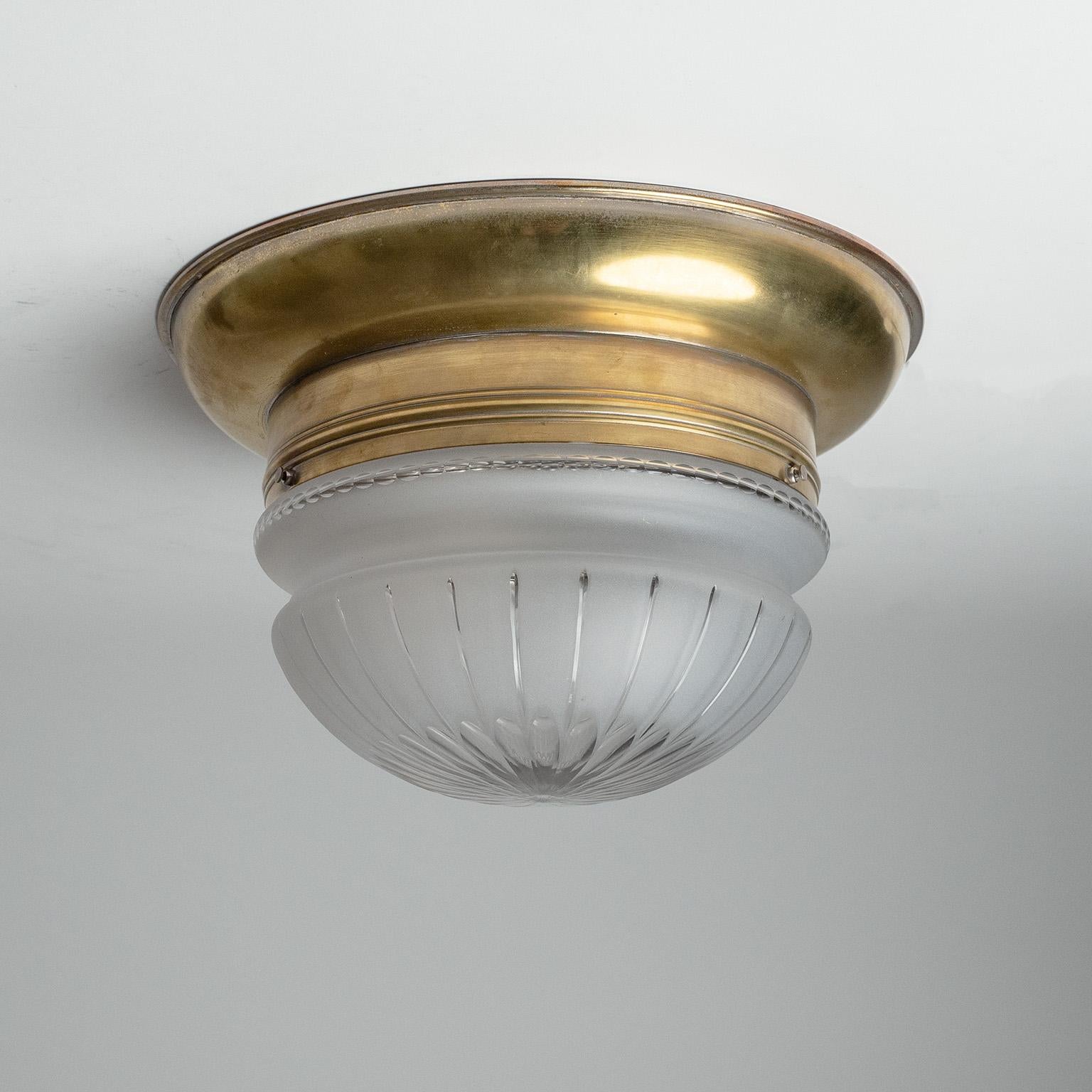 Fine Austrian brass flush mount with intricately cut glass diffuser from the 1920s. Very high quality glasswork, frosted on the outside and cut with a lovely geometric pattern. The inside of the brass body is nickel-plated and has three original