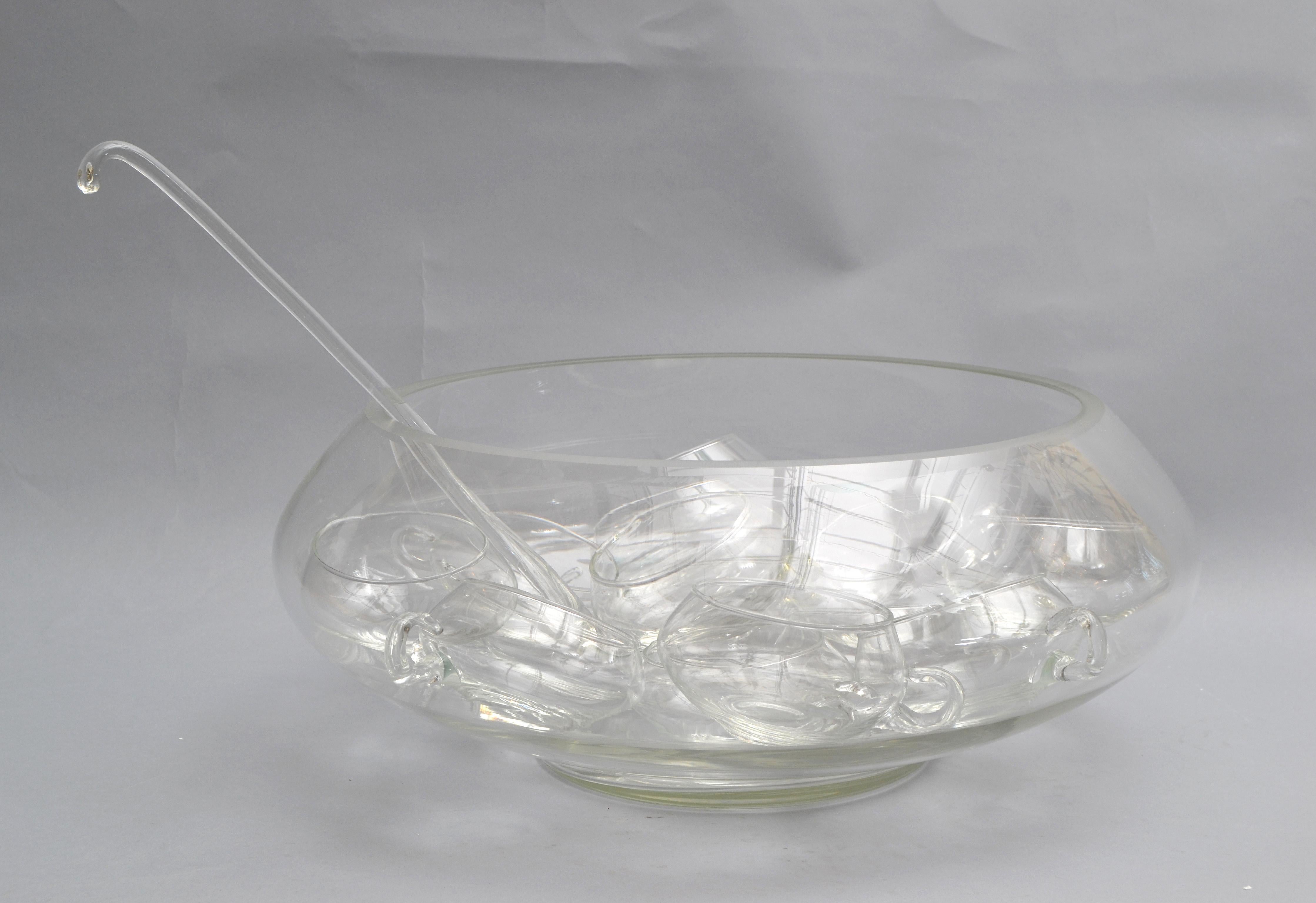 In excellent condition is this 14-piece blown glass punch bowl set made in Italy.
The set is consisting out of a large punch bowl with 12 glass cups and a ladle.
Great for hosting in the Holiday Season.
Dimensions: 
Cups: Height: 2.5 inches, Depth: