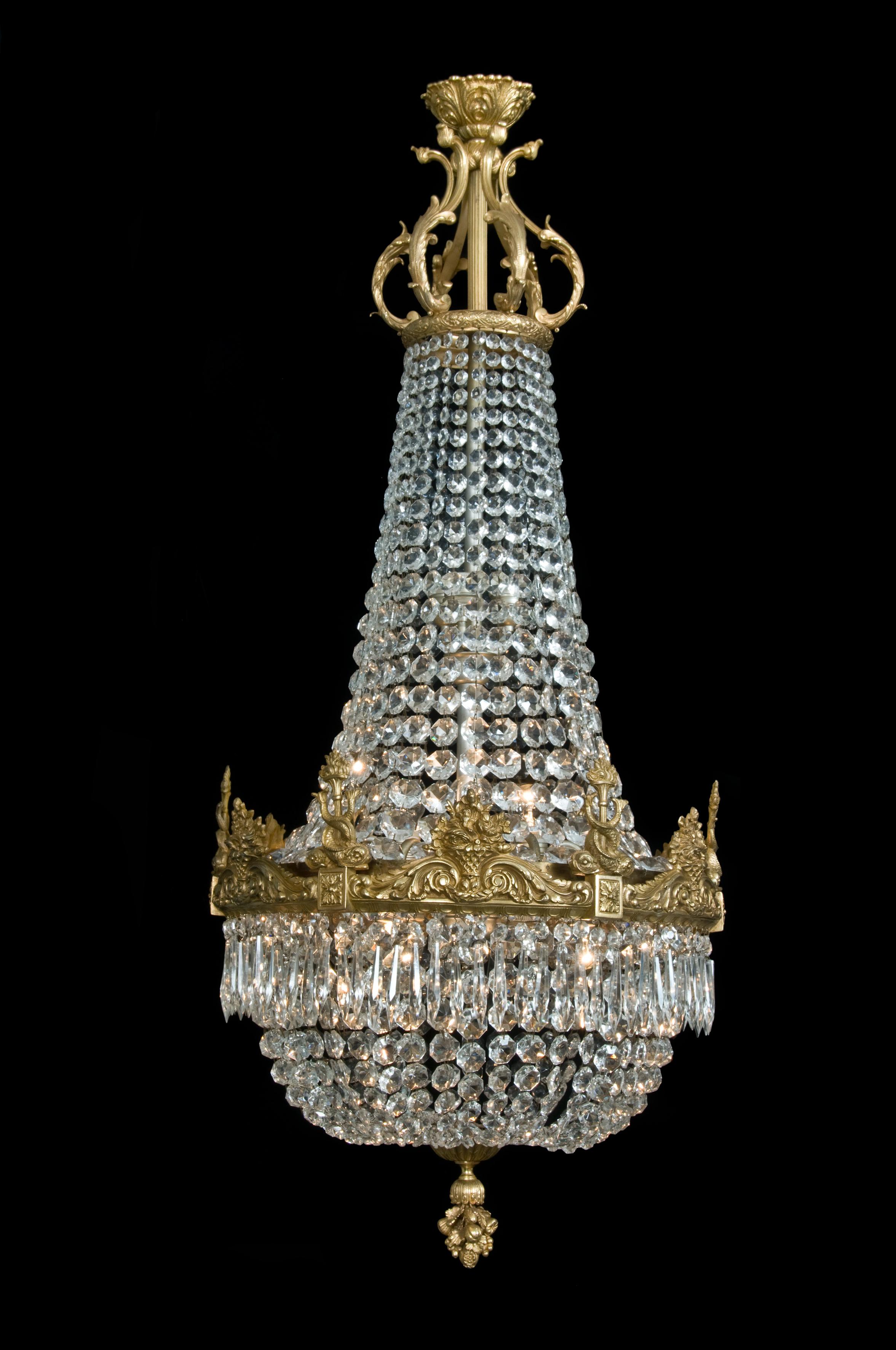 A fine gilt-bronze cut-glass tent and bag chandelier with finely cast entwined dolphins.

French, circa 1900.

This fine chandelier has a gilt-bronze acanthus corona above a foliate band, from which is suspended chains of graduated octagonal