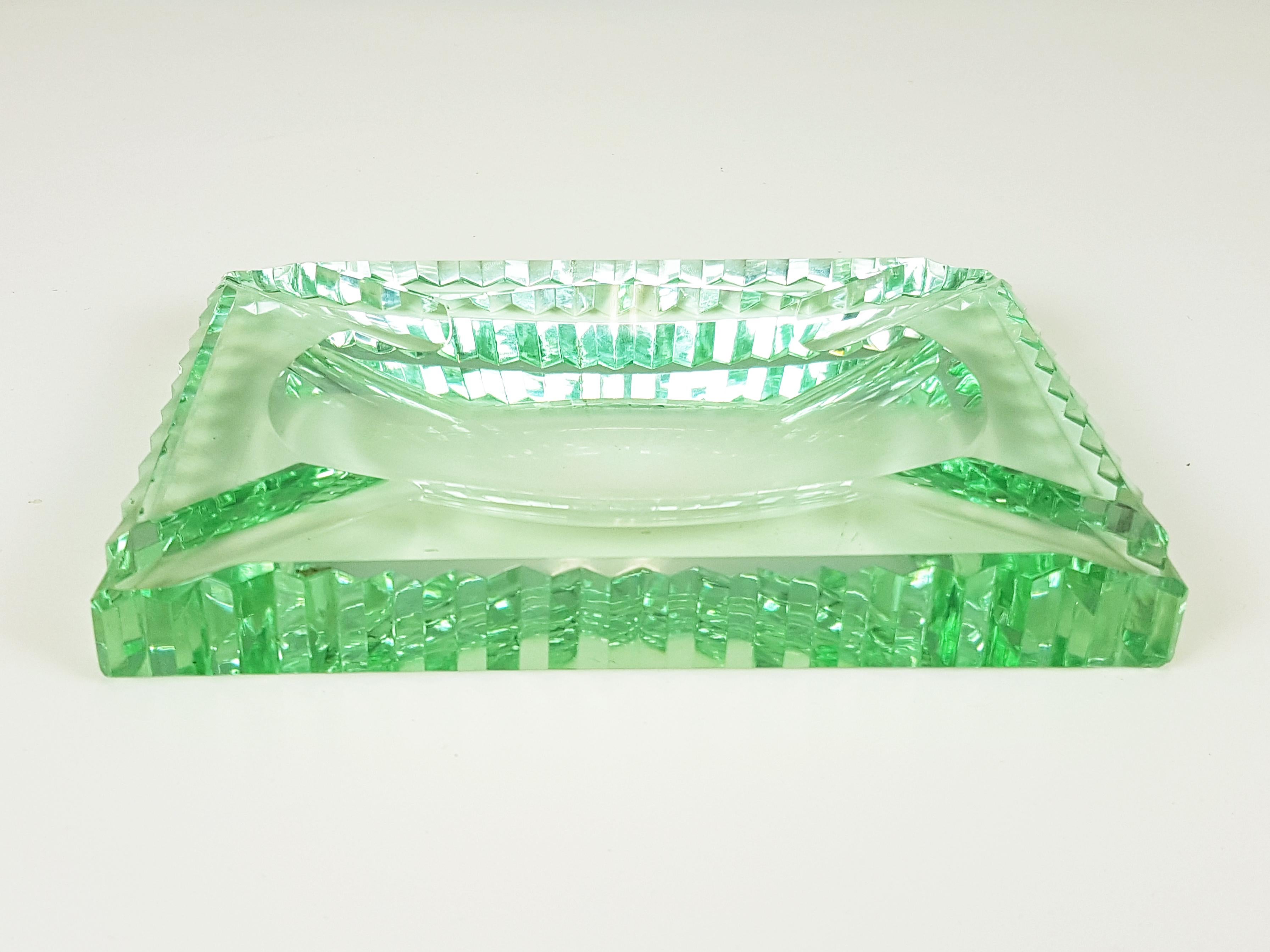 Green glass ashtray with grinded shape in the manner of Fontana Arte. One small dent on the corner.