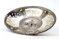 Cut-out silver fruit bowl with central floral relief and pearled rim