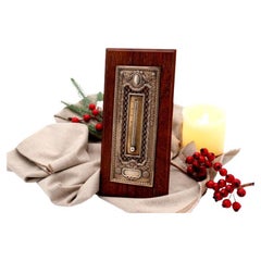 Cut-out silver thermometer with monogram card 
wooden stand