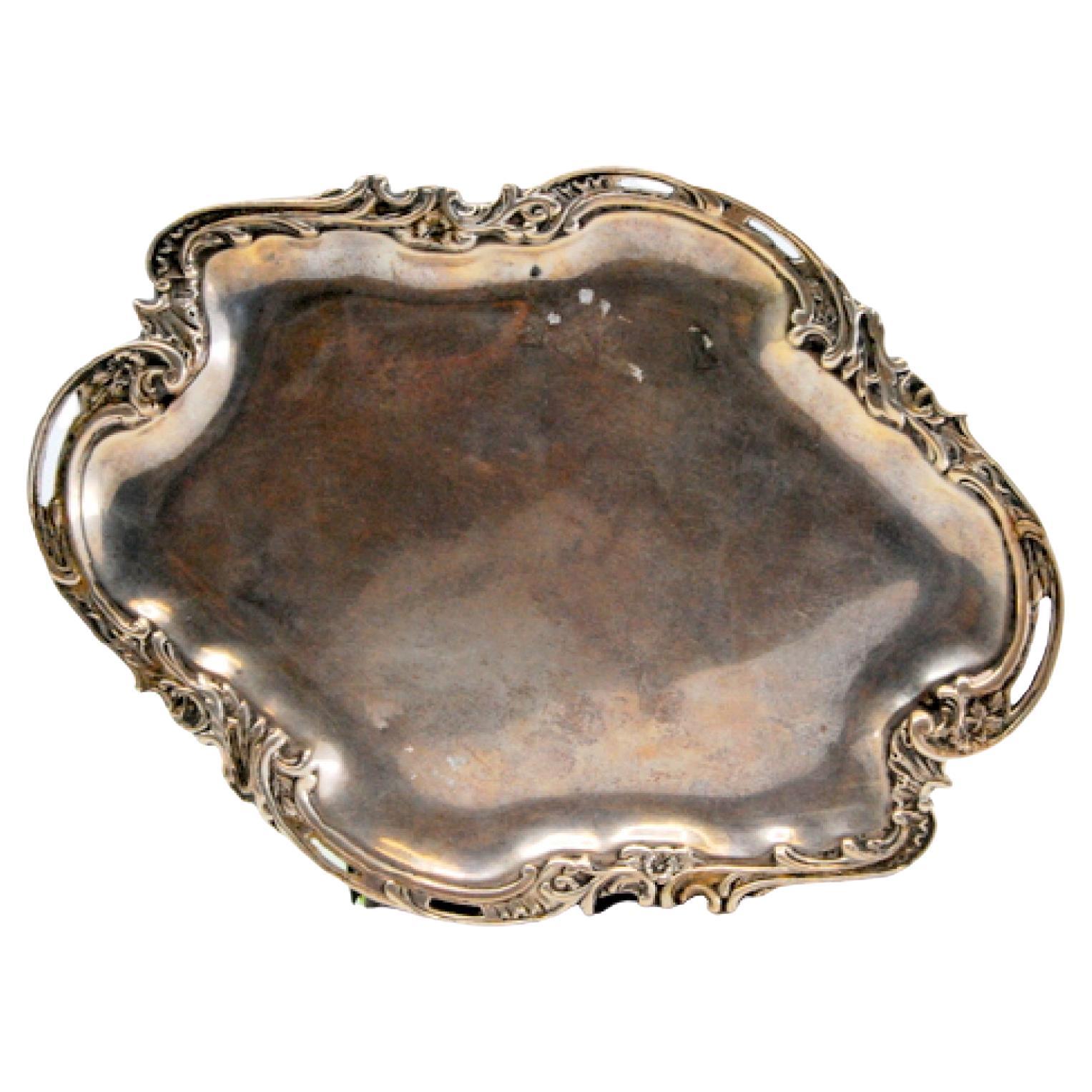 Cut-out silver tray, with reliefs and friezes surrounding the smooth bottom
