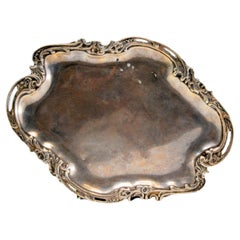 Cut-out silver tray, with reliefs and friezes surrounding the smooth bottom