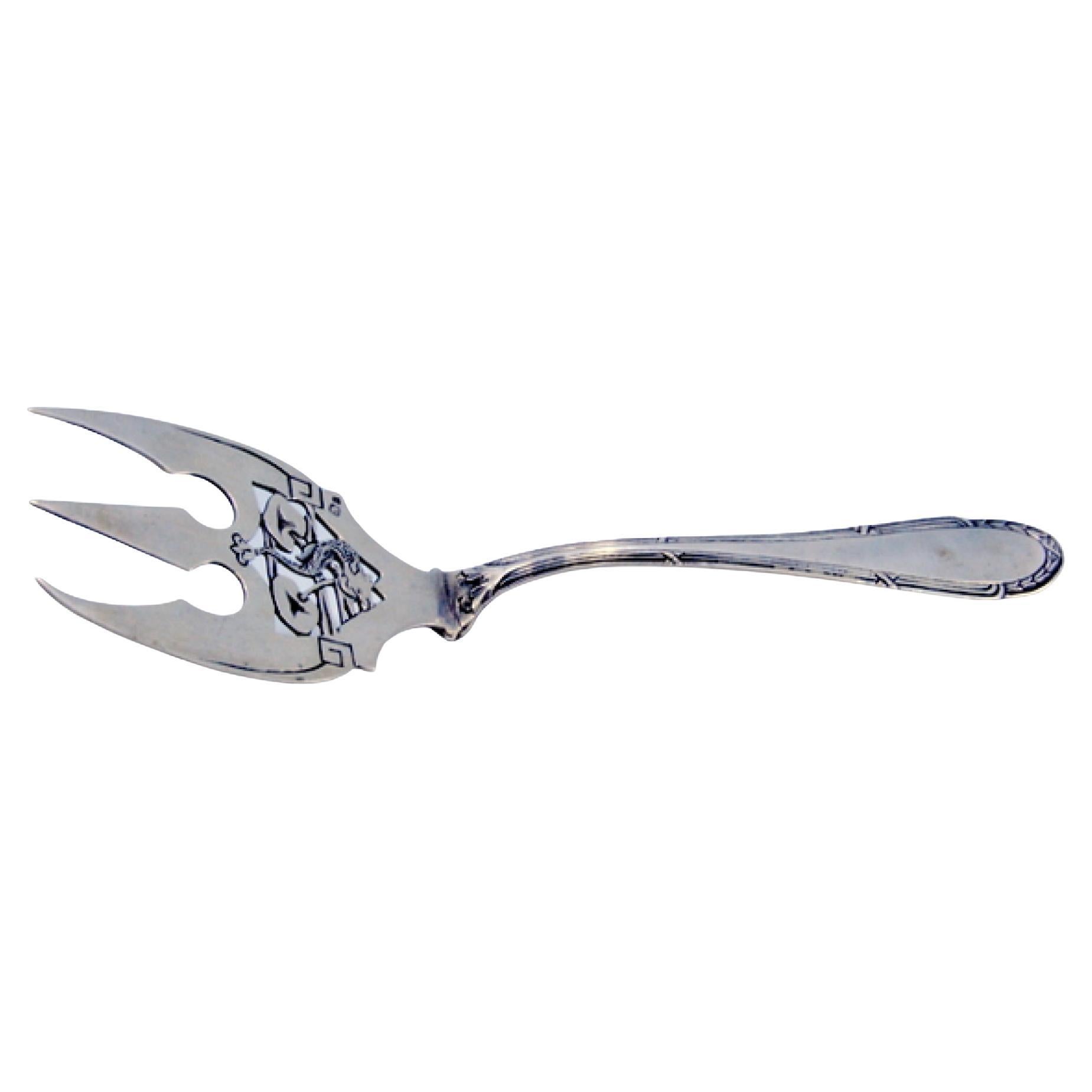 Cut silver fish fork with engraved tines and handle friezes