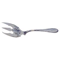 Cut silver fish fork with engraved tines and handle friezes