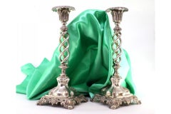 Cut silver spiraled candlesticks with acanthus-cut bases and embossed feet