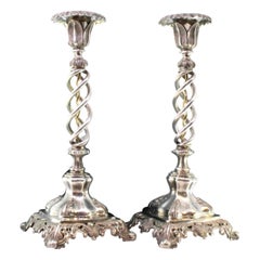 Cut silver spiraled candlesticks with acanthus-cut bases and embossed feet